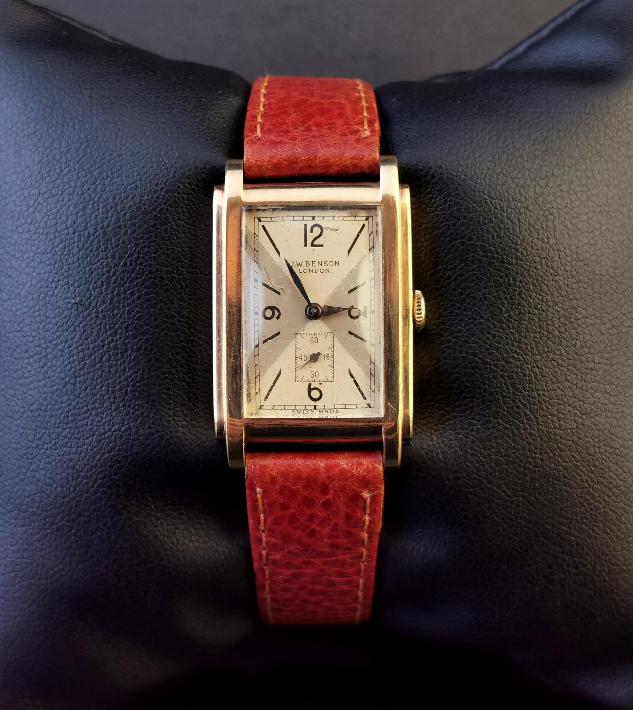 A handsome vintage 9kt yellow gold Gents wristwatch.

Made by the renowned JW Benson, movement marked JW Benson England and Swiss make. 

It has a rectangular yellow gold case with a champagne enamel dial with black Arabic numerals and hands and a