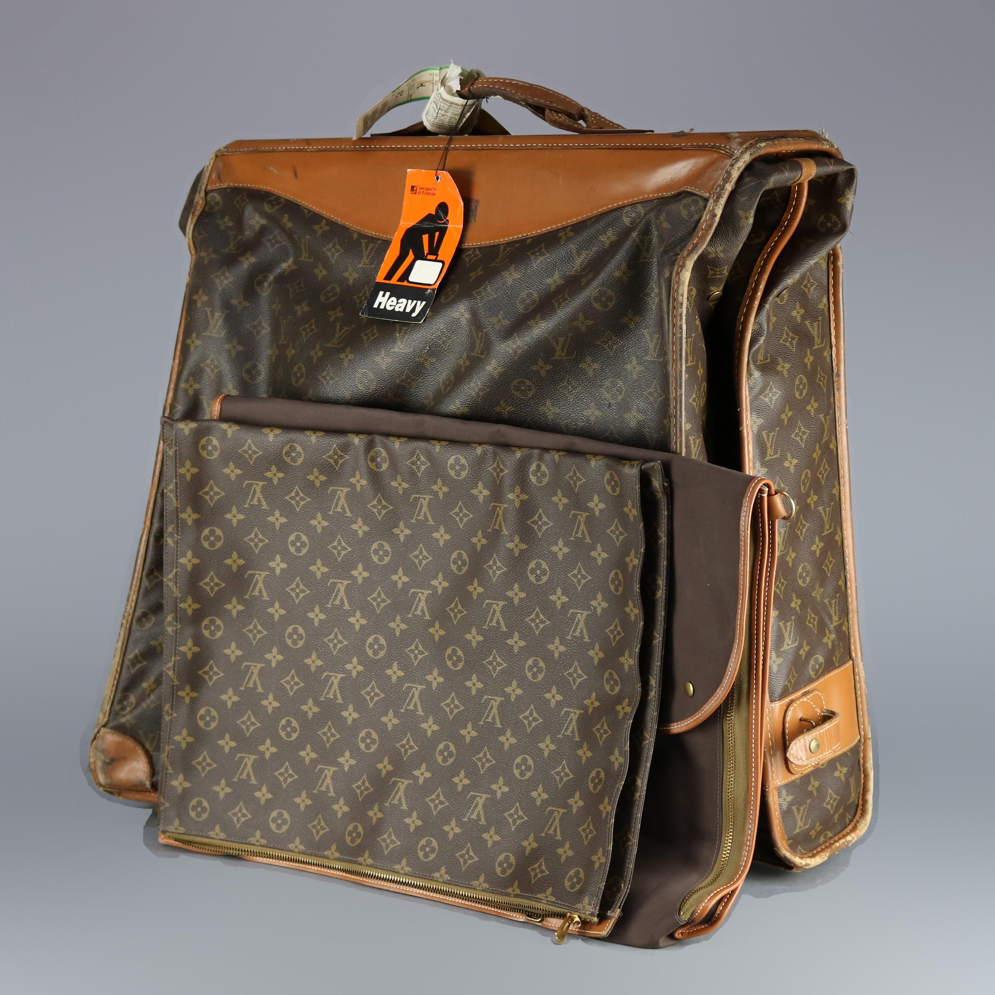 A genuine French folding Louis Vuitton designer garment bag includes accessory pouches as photographed, 20th century.

Measures: 58