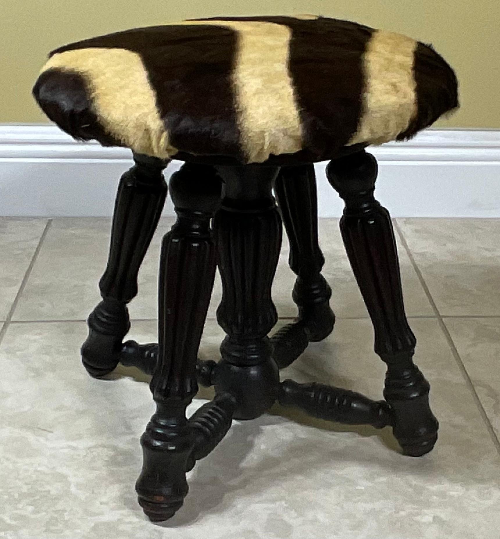 Elegant foot stool made genuine zebra hide top mounted on solid antique wood carved decorative base.
Great decorative item for any room.
 