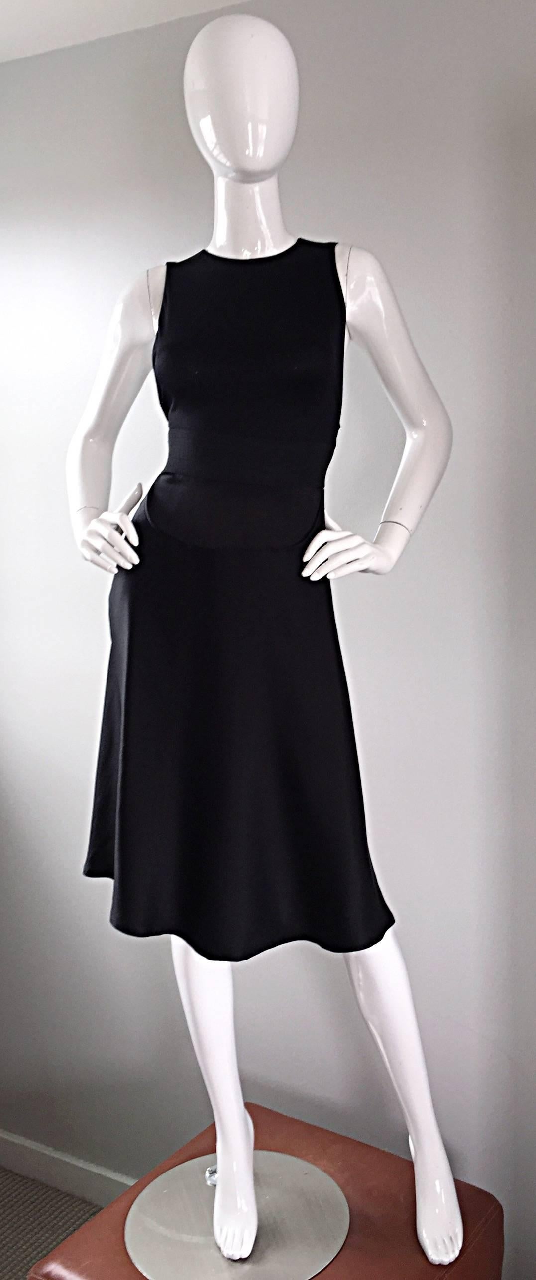 Amazing 90s GEOFFREY BEENE black silk minimalist dress! Features a flattering stretch criss-cross back, with black zipper. Banded waist, with a dipped flounced hem. Hidden zipper up the back of the skirt, with hook-and-eye closure. Signature Beene