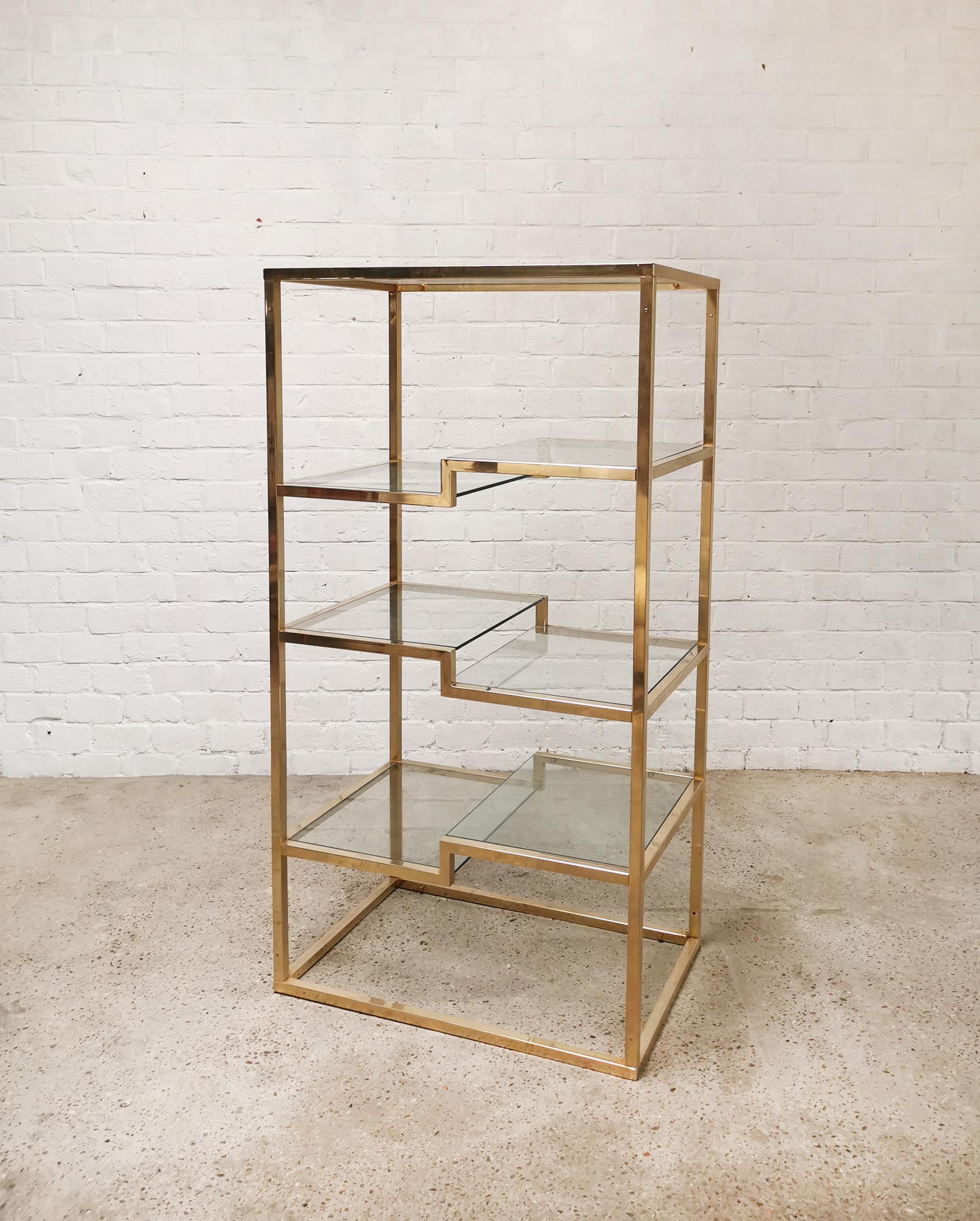 Gold plated geometric etagère by Belgo Chrom, produced in the 1970’s. This console is also often attributed to Romeo Rega. It features beautiful unique geometric shelves with thick clear glass panels. Makes a stunning wall display for your plants,