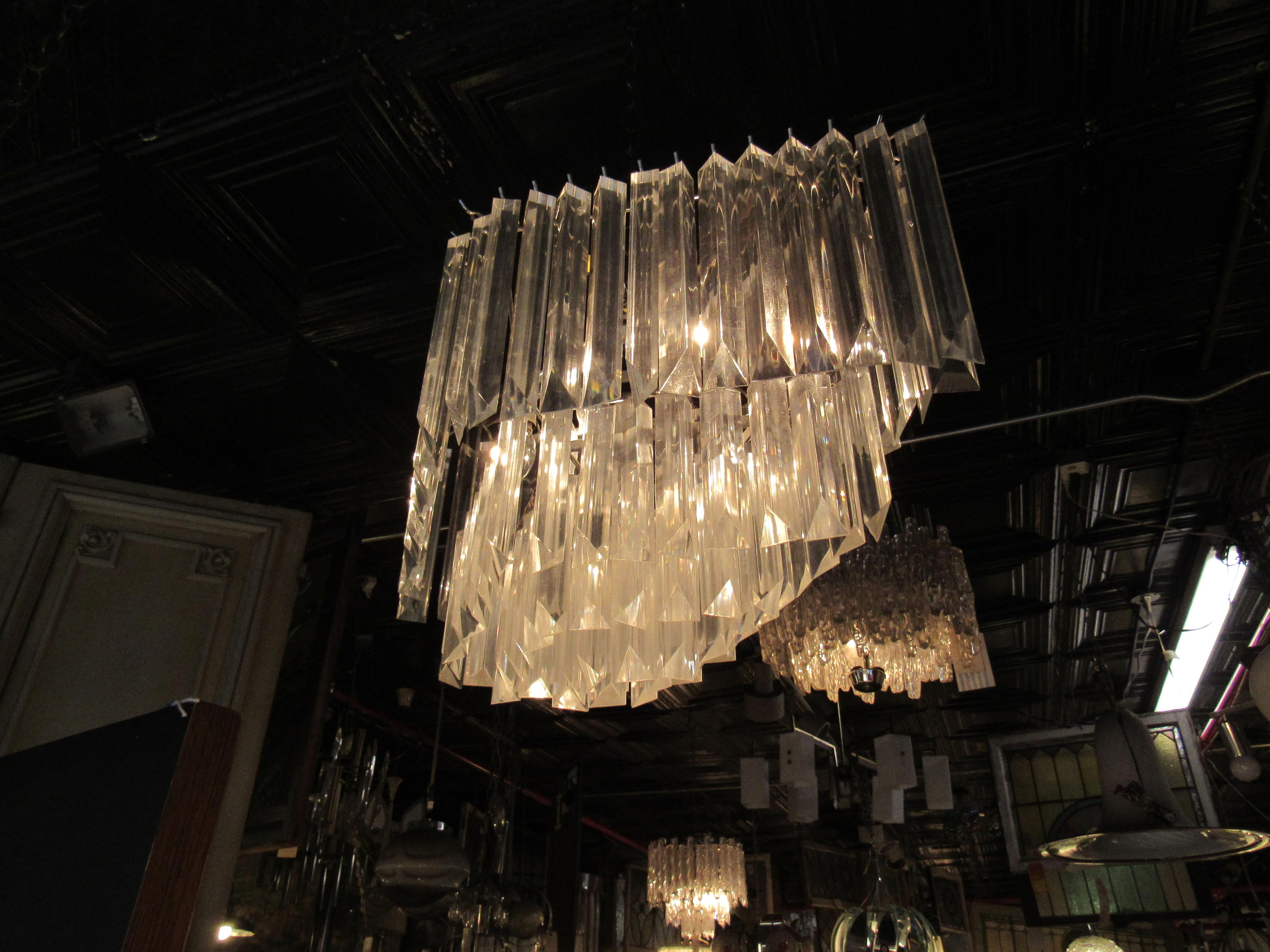This large diamond-shaped chandelier is made up of four tiers of lucite prisms, which filter light through to stunning effect. Please confirm item location with seller (NY/NJ).