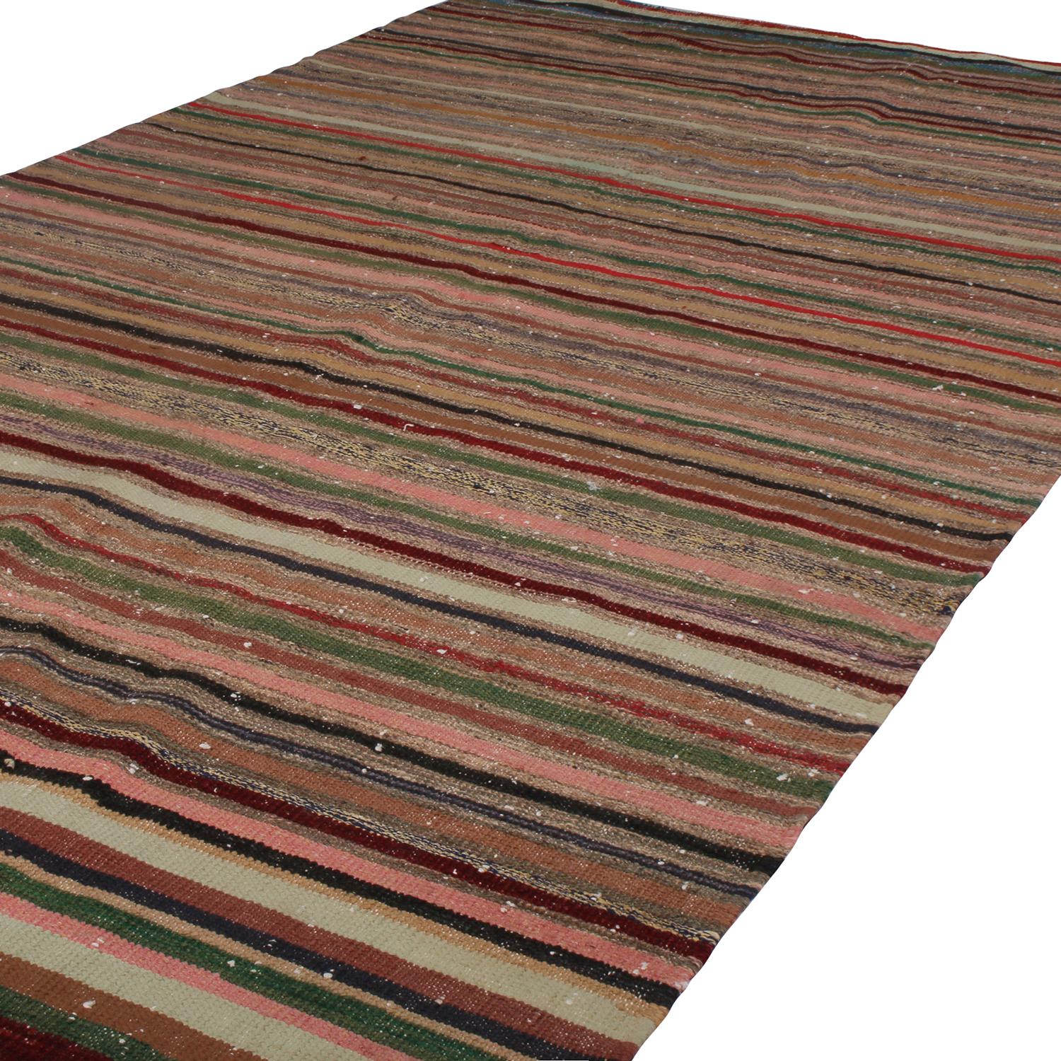 Handwoven in Turkey originating between 1970-1980, this vintage wool kilim rug enjoys a play of subtle, intricate colorway variation and shabby-chic, classic texture complementing the striped pattern. The lively juxtaposition of rich beige brown