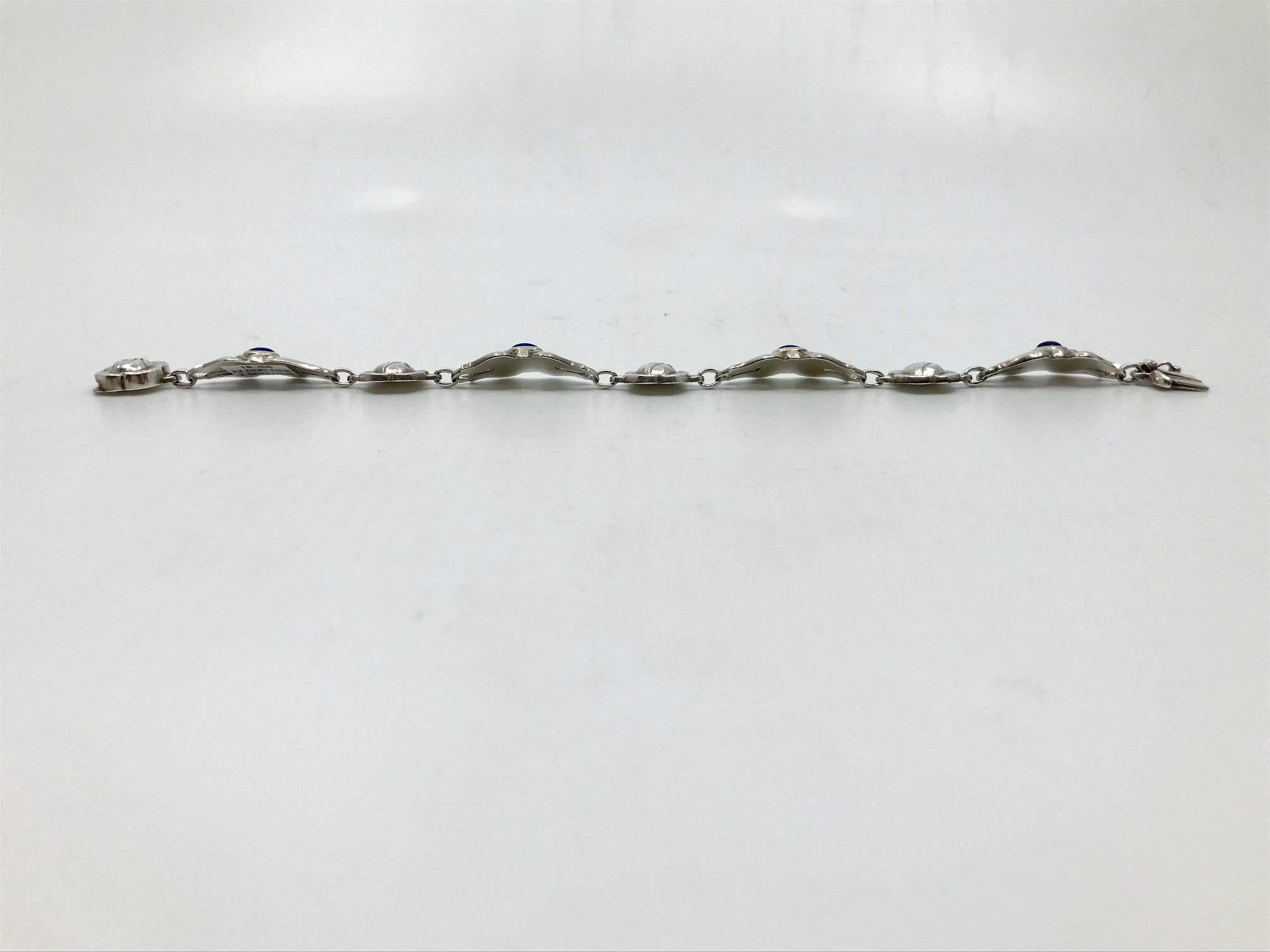 Vintage sterling silver Georg Jensen bracelet with lapis lazuli, design #18 by Georg Jensen.

Measures 7½” in length, the links are ½” across (19.2cm, 1.3cm). The links are curved for a better fit.

Vintage Georg Jensen hallmark from 1933-1944.