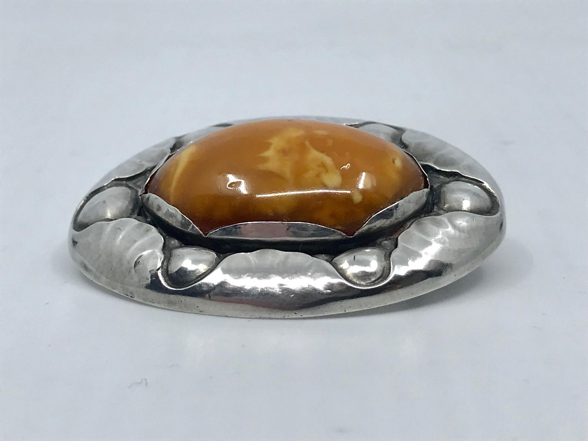 Rare vintage silver Georg Jensen brooch with a large oval amber stone, design #119 by Georg Jensen from circa 1913.
Measures 2 1/8 x 1 5/8″ (5.5cm x 4.2cm).
Vintage Georg Jensen hallmarks from 1915-1919, 830s.