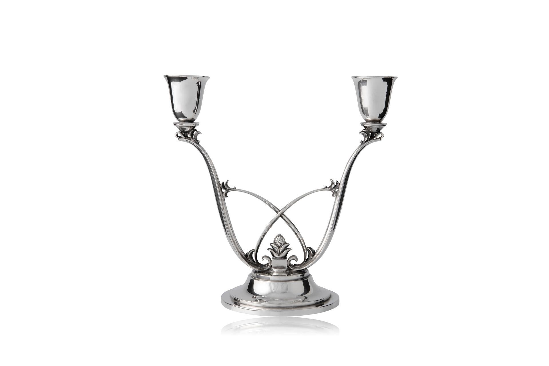 A pair of vintage Georg Jensen sterling silver two-light candelabra, design #619 by Harald Nielsen from circa 1930.

Additional information:
Material: Sterling silver
Styles: Art Deco
Hallmarks: Vintage Georg Jensen hallmarks from