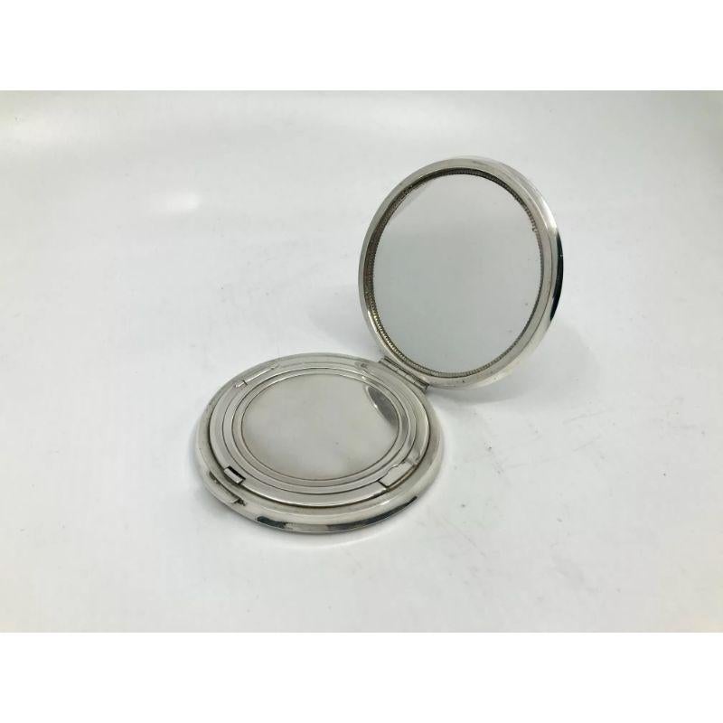 This is a sterling silver Georg Jensen compact, design #278AA by Sigvard Bernadotte from circa 1940. Classic Bernadotte design, simple, elegant and functional. A button on the front releases the main lid, a second button inside releases the powder