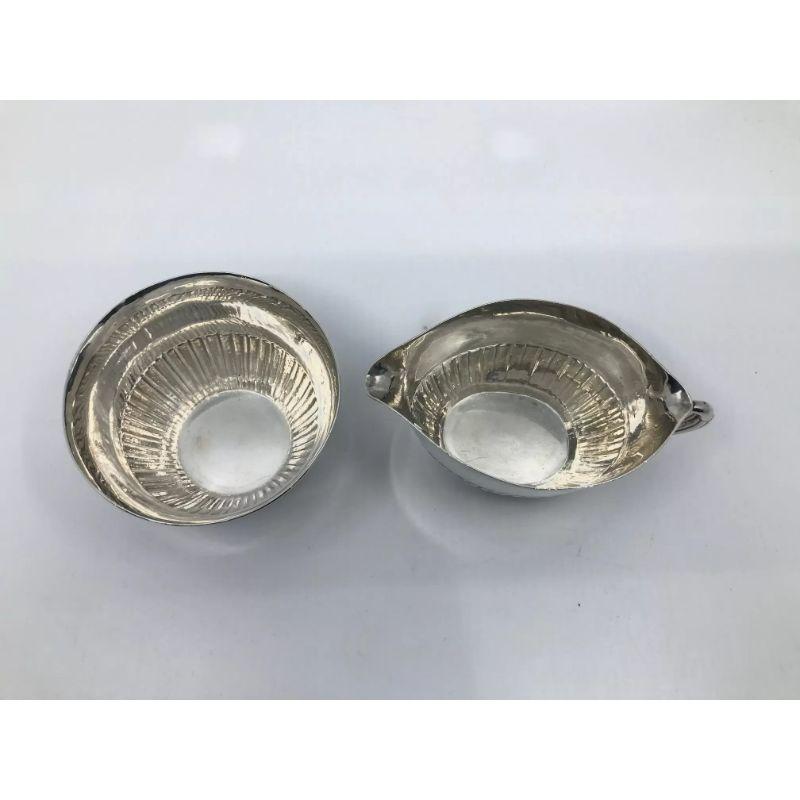 A sterling silver Georg Jensen sugar & creamer, design #45A by Johan Rohde from 1915. This design often called “Cosmos”, this was the original sugar & creamer set, shortly after release the better known version with a lidded sugar bowl and ebony