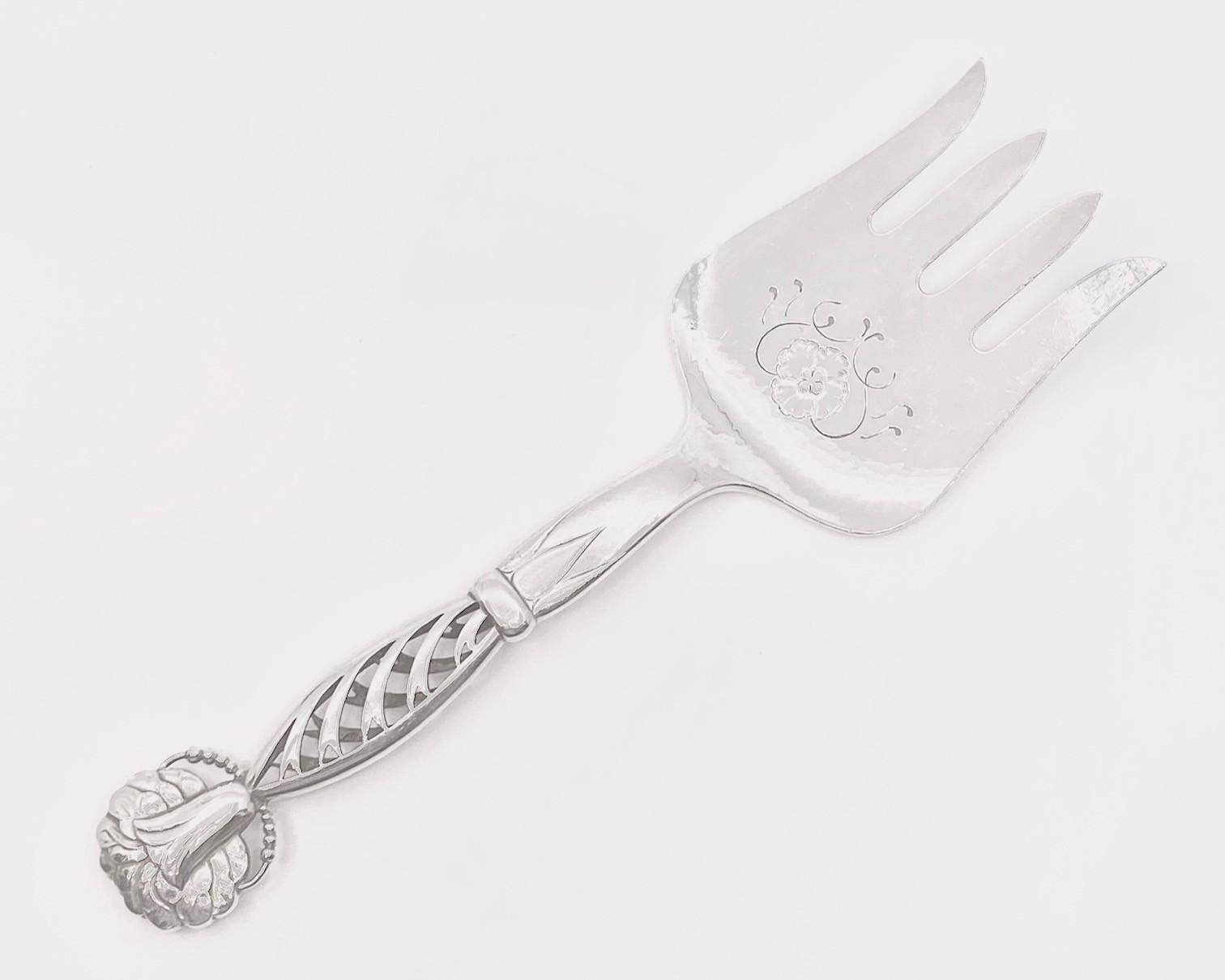 This is a large sterling silver Georg Jensen fish serving fork, in Ornamental pattern #83 by Georg Jensen from circa 1914.

Additional Information:
Material: Sterling Silver
Style: Art Nouveau
Hallmarks: With post 1944 Georg Jensen hallmark, made in