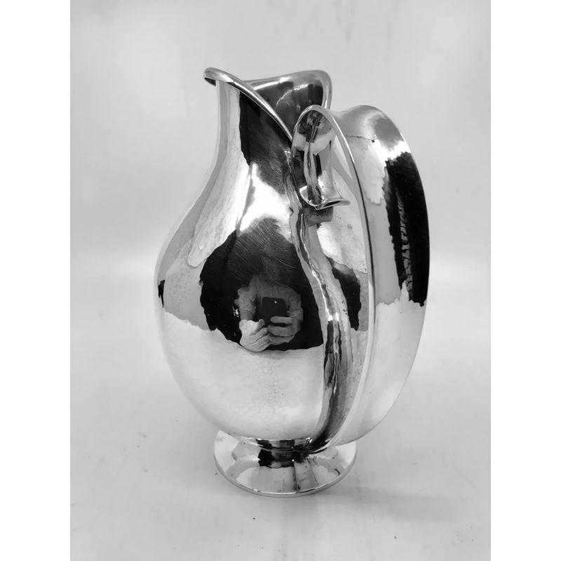 A rare sterling silver Georg Jensen Art Deco pitcher, design #319A by Harald Nielsen from circa 1928.

Additional information:
Material: Sterling silver
Styles: Art Deco
Hallmarks: Vintage Georg Jensen hallmark from 1945-1977.
Dimensions: Measures