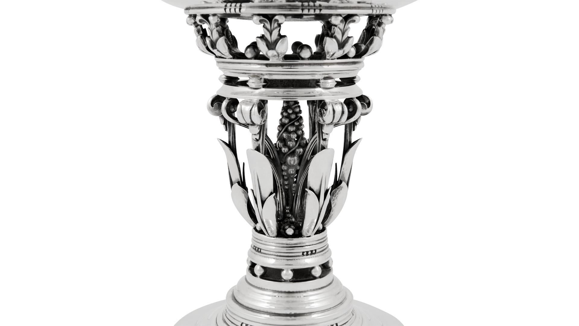 This is a large sterling silver Georg Jensen compote, design #252 by Johan Rohde from circa 1918 and known as the “Princess” bowl.
Classic Johan Rohde design with openwork stem decorated with leaves, berries and scrolls.
Measures 9