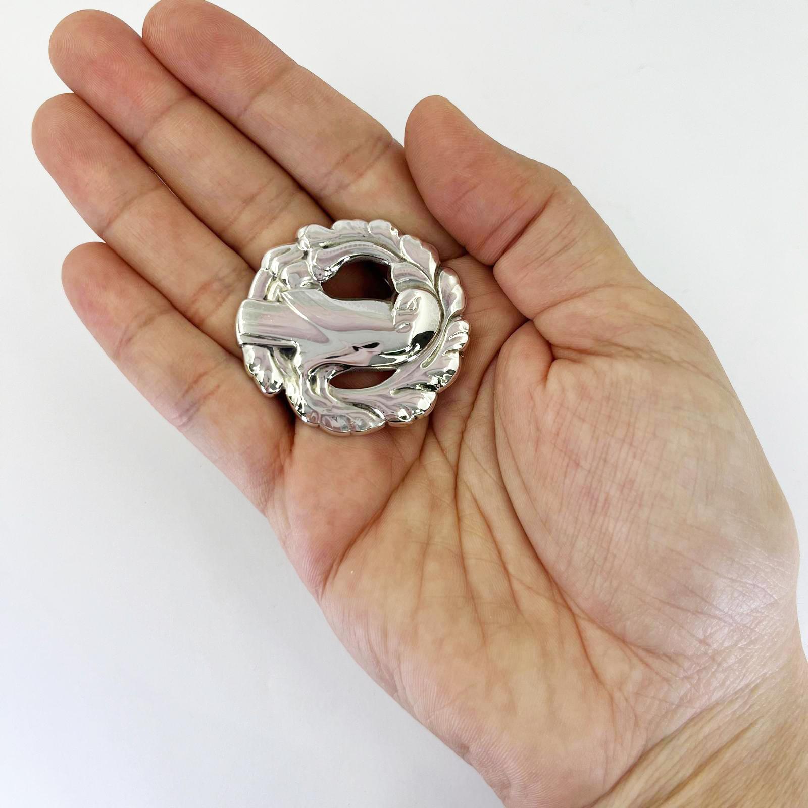 Georg Jensen round brooch #165 featuring a bird on a wreath. 1.75 inch diameter. $500 MSRP.