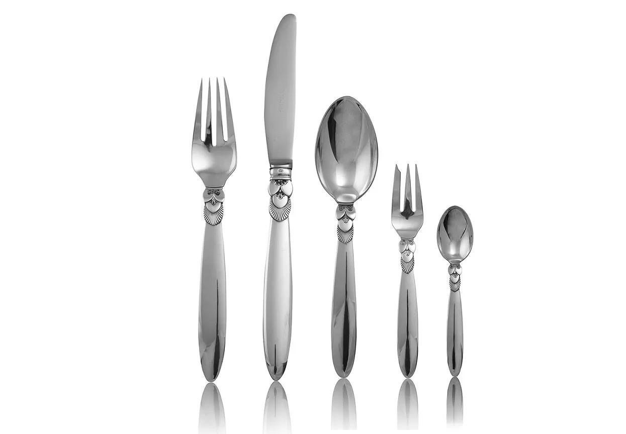 A Georg Jensen sterling silver Cactus silverware service for twelve persons. It was created by sculptor Gundorph Albertus in 1930. The lines are simple and strong and his sensitivity for Silver´s character are clearly pronounced in the stylized