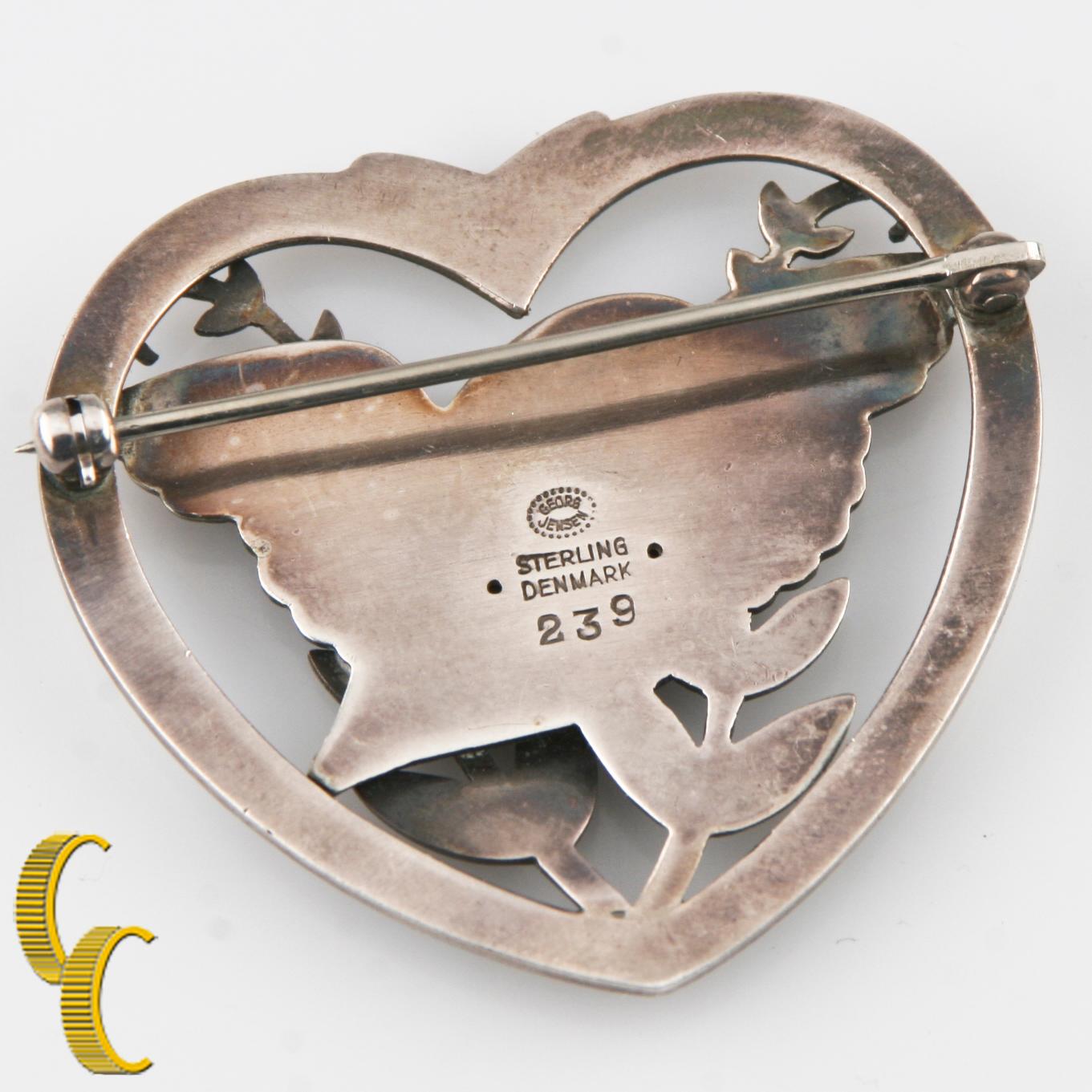 Vintage Georg Jensen Design of a Dove Carrying an Olive Branch in a Heart Frame
Brooch/Pin
Total Mass: 13.1 Grams.
An Amazing Gift. Vintage, Rare, Retired Piece!