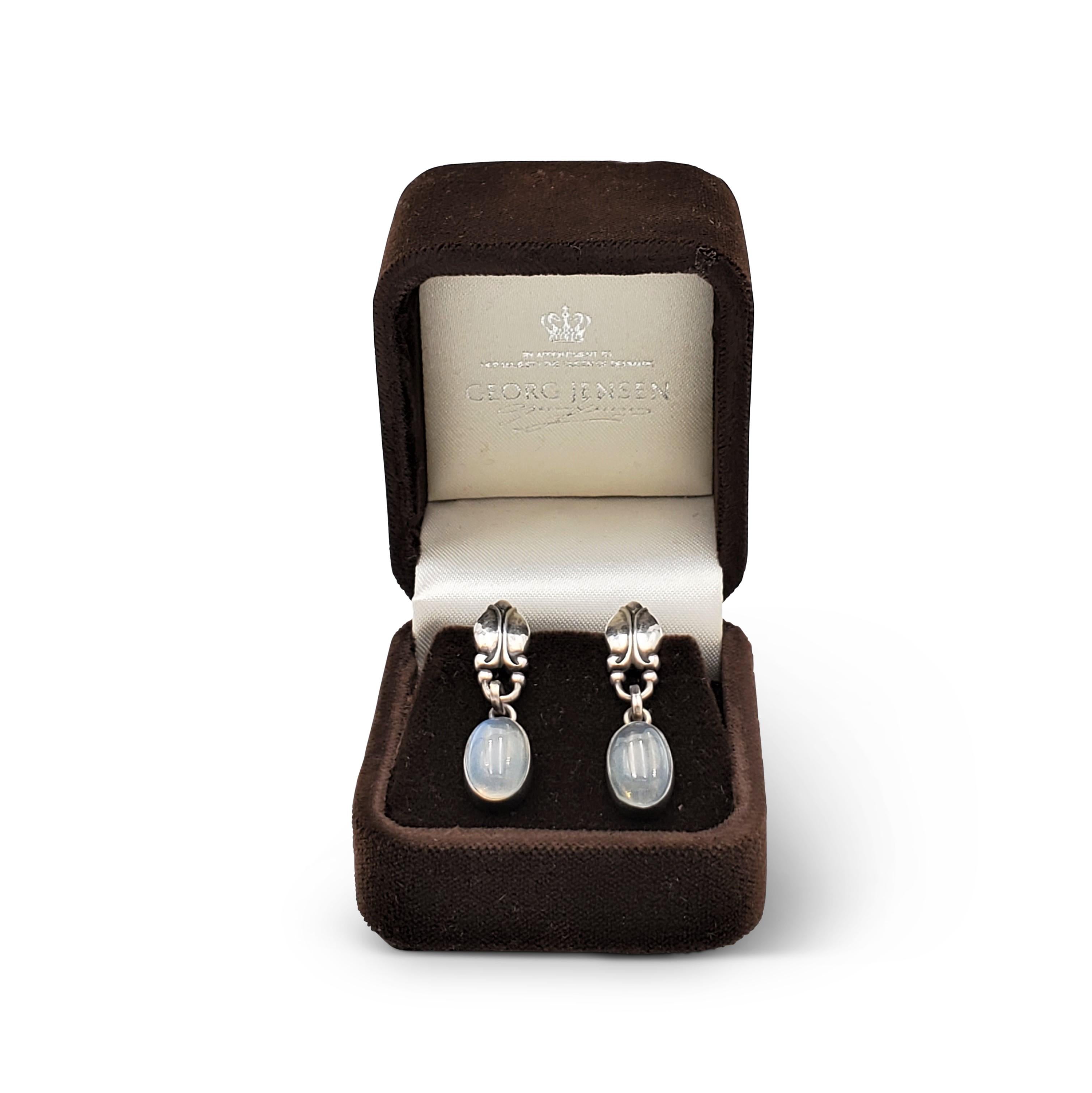 Authentic vintage Georg Jensen sterling silver earrings featuring moonstone drops. Signed Georg Jensen, 925 S, Denmark, 17. The earrings are presented with the original box, no papers. CIRCA 1960s.