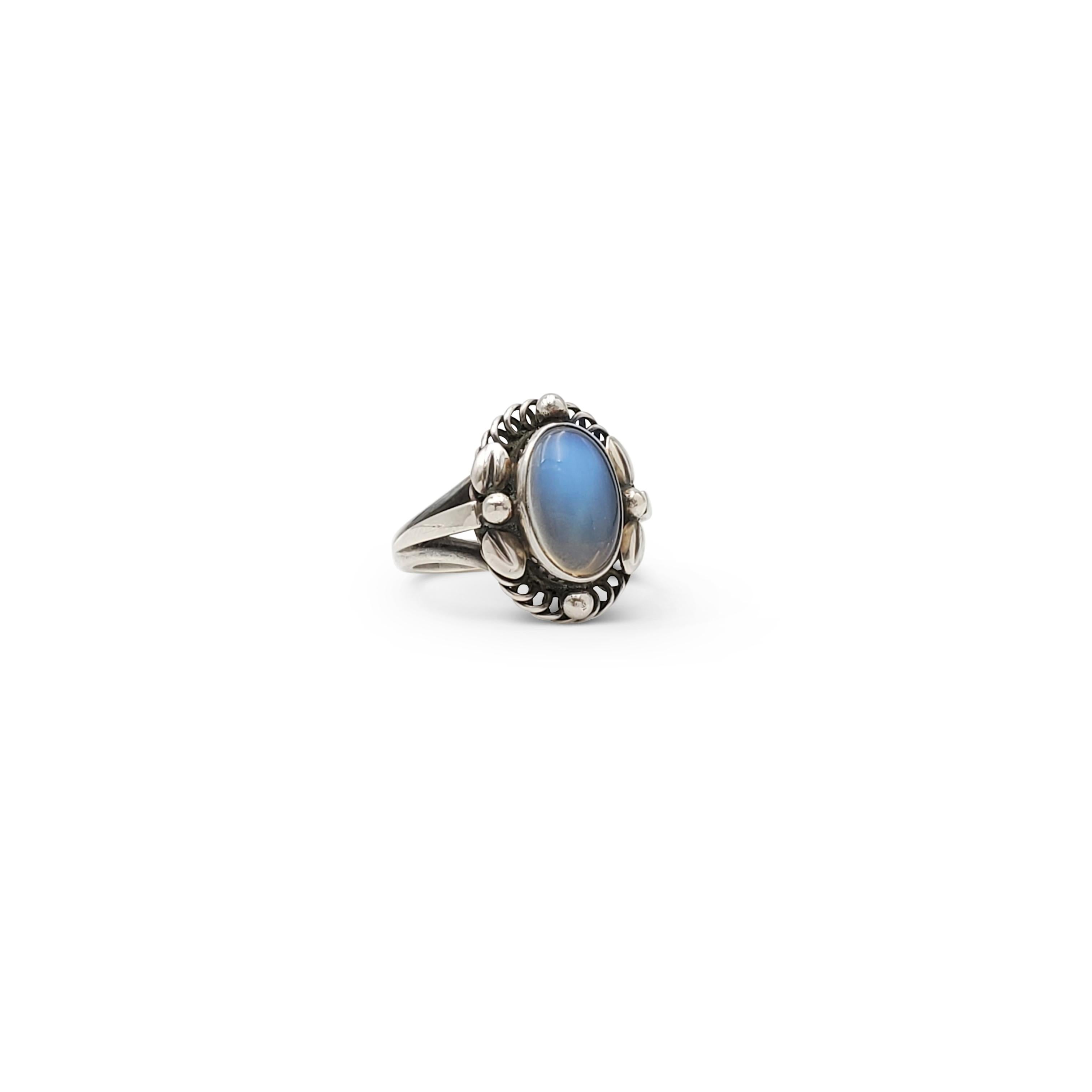 Authentic vintage Georg Jensen sterling silver ring featuring a lively opalescent moonstone. Signed Georg Jensen, 925 S, Denmark, 1A. Ring size 5 1/2. The ring is presented with the original box, no papers. CIRCA 1960s.
