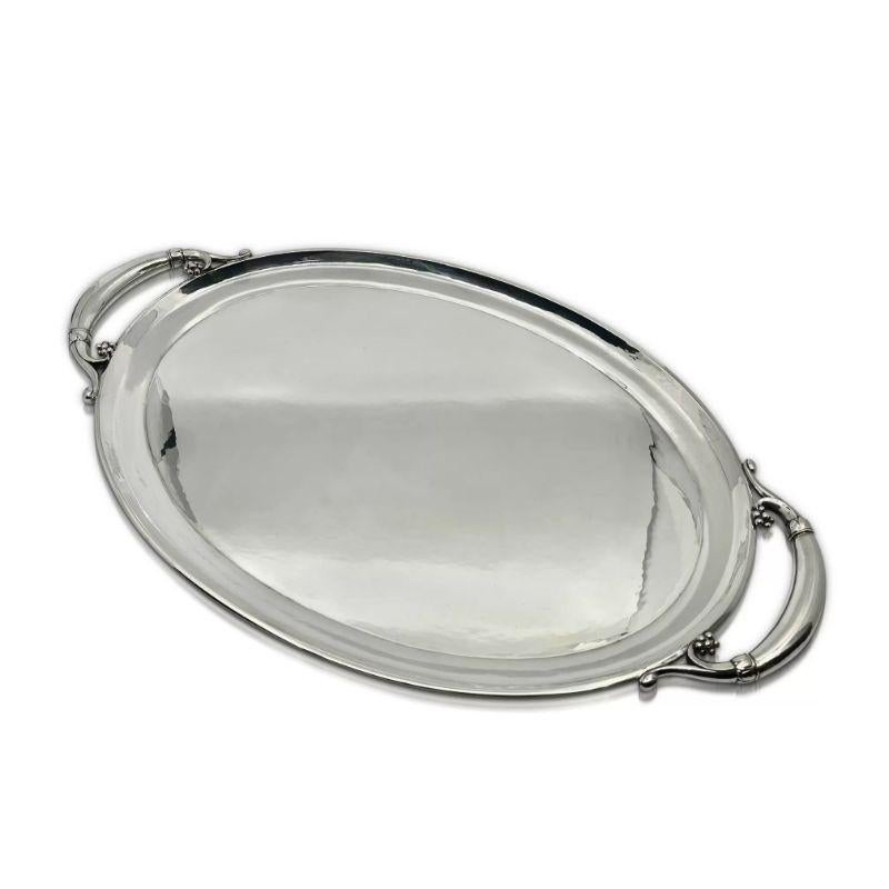A medium size sterling silver Georg Jensen oval tray with handles, design #32C by Georg Jensen from circa 1912. This tray matches the tea/coffee service with the same design number #32.

Additional information:
Material: Sterling silver
Styles: Art