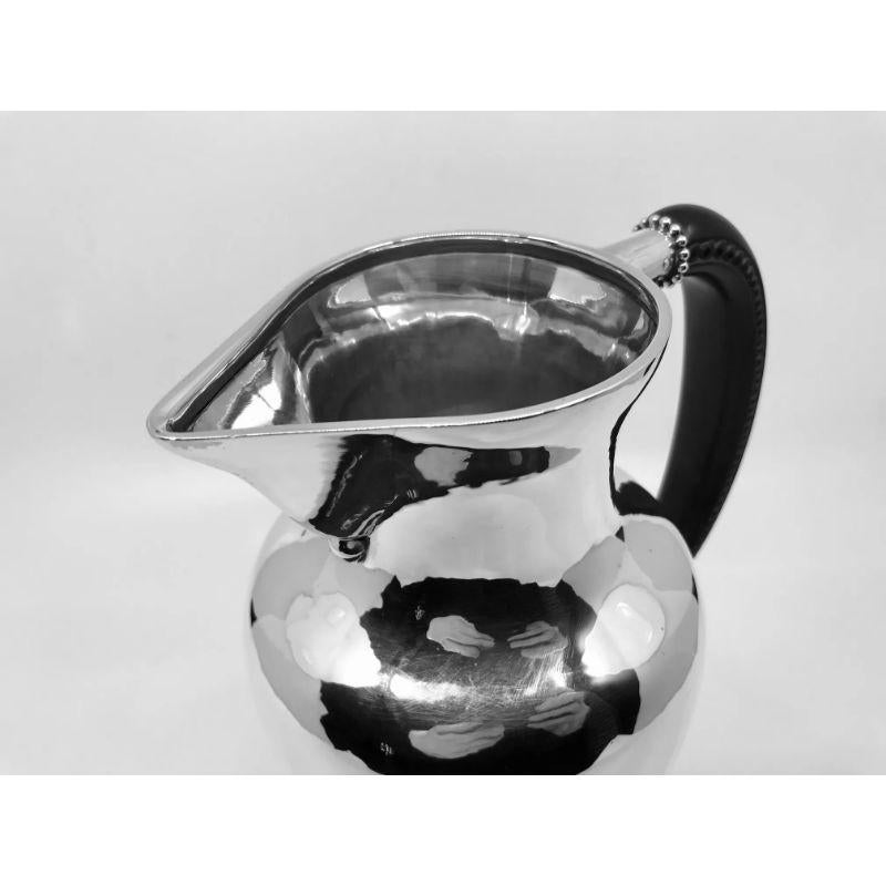 Vintage sterling silver Georg Jensen pitcher with ebony handle, simple and elegant design, design #5 by Georg Jensen from 1910. Beautiful hand carved details on the ebony handle.

Additional information:
Material: Sterling silver
Styles: Art