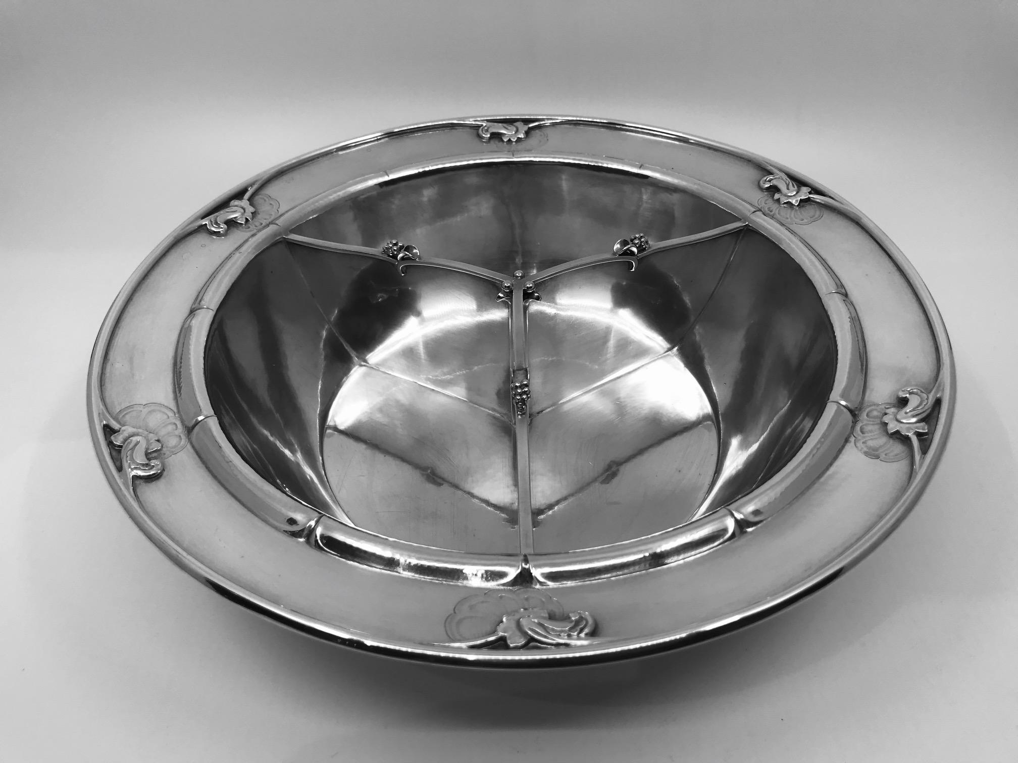This is a sterling silver Georg Jensen vegetable bowl with a fixed inbuilt divider, dividing the bowl into three sections, design #228C by Georg Jensen.

Measures: 2 3/4? in height and 11? in diameter (7cm, 28cm). This piece is heavy, weighing