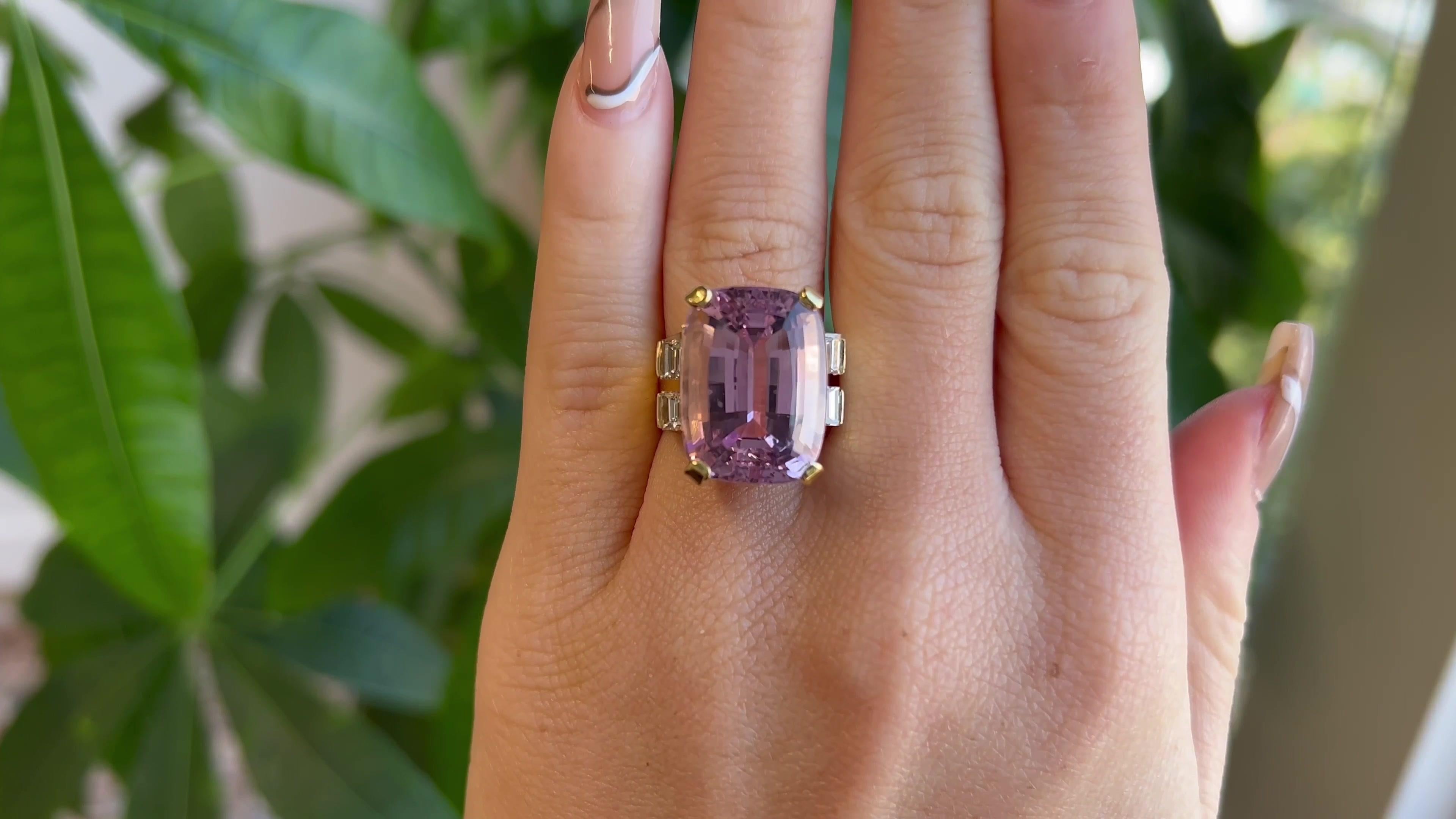 One Vintage George Brooks Modernist 21.60 Carat Kunzite Diamond 18 Karat Yellow Gold Cocktail Ring. Featuring one cushion shaped step cut Kunzite of approximately 21.60 carats. Accented by four baguette cut diamonds of approximately 0.50 carat,