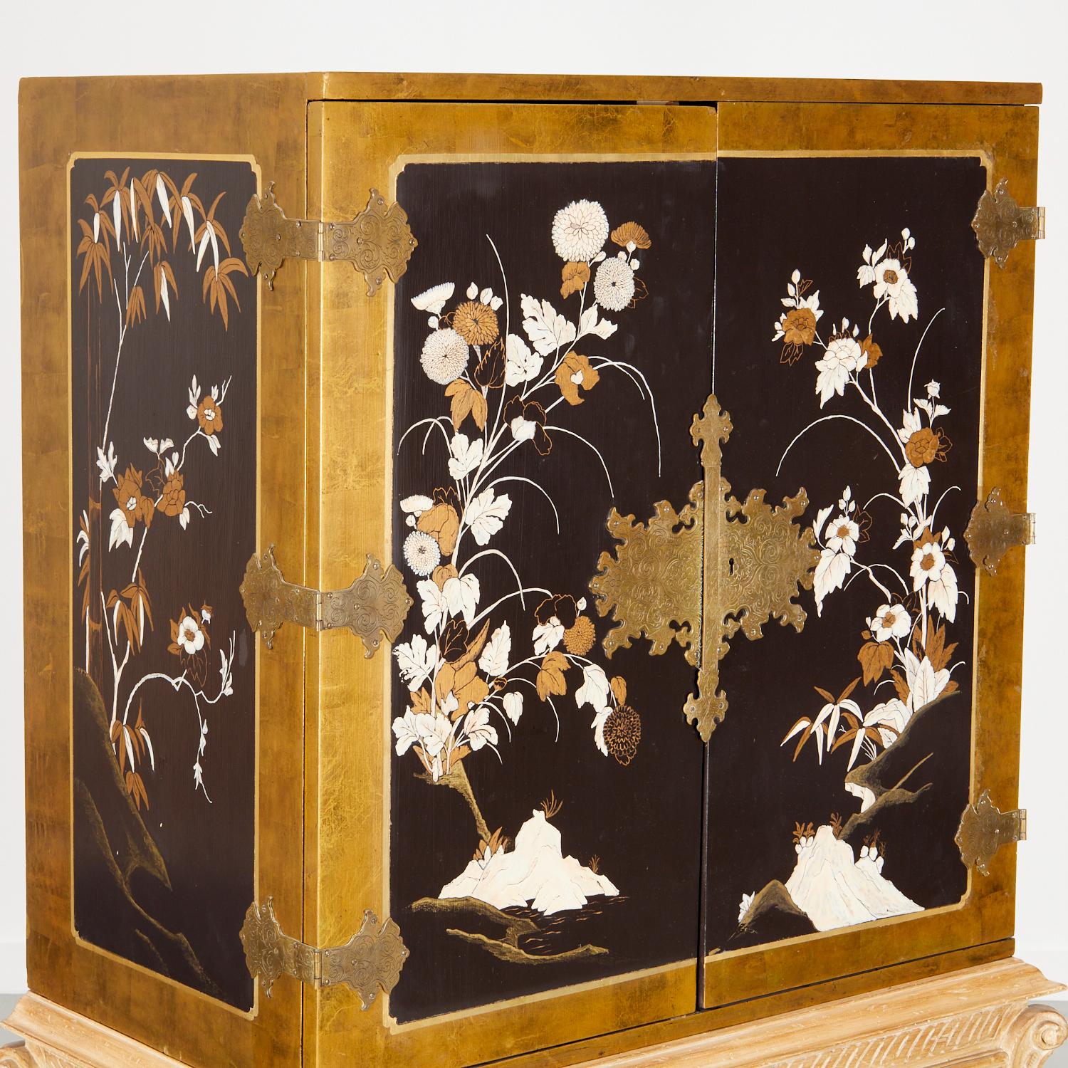 An unusual and striking statement piece, vintage 20th century, Chinoiserie engraved brass mounted lacquer cupboard on a shell-carved stand with cabriole legs, unmarked. The front and sides of the cabinet are decorated with delicate floral details