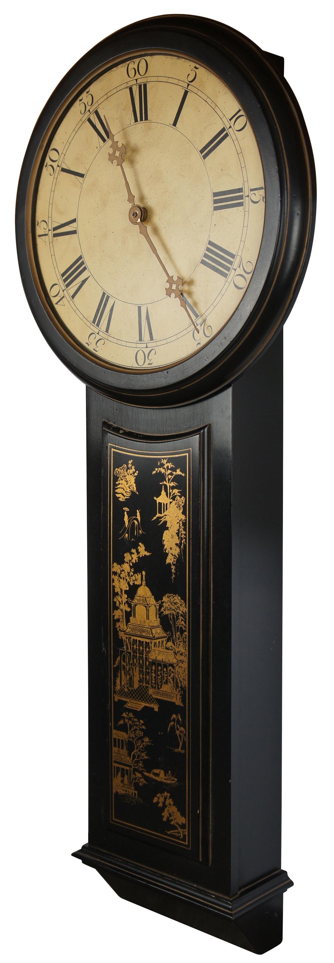 George III style Black & Gold chinoiserie wall clock. Made in the form of a Tavern or Act of Parliament Clock. Front panel features a water scene with pagodas and figures. Features a round face with roman numeral and gold painted hands. Battery