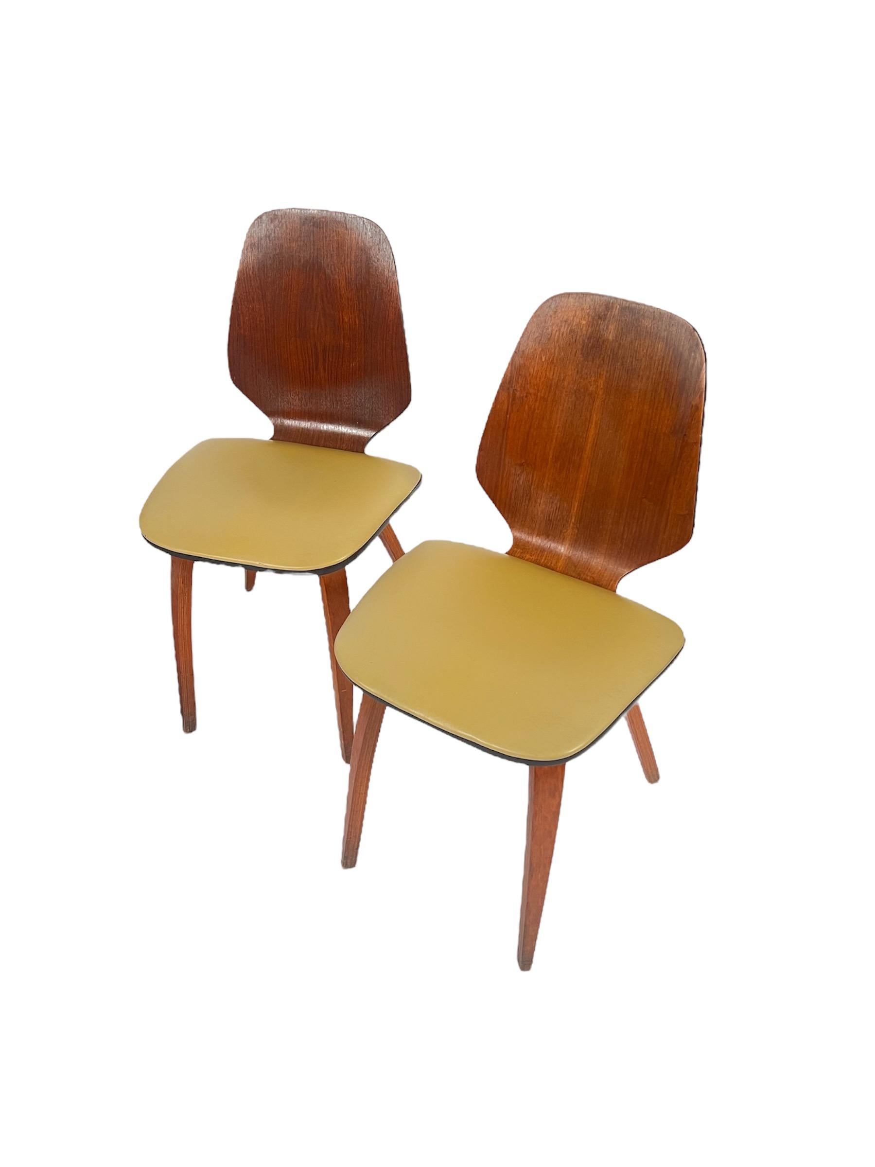 Handsome set of four Vintage Mid Century Bentwood Dining Chairs designed by George Mulhauser for Plycraft. Chairs are in used vintage condition. Wear to chair legs and seat cushions are present. Some very small tears in two chairs seats.