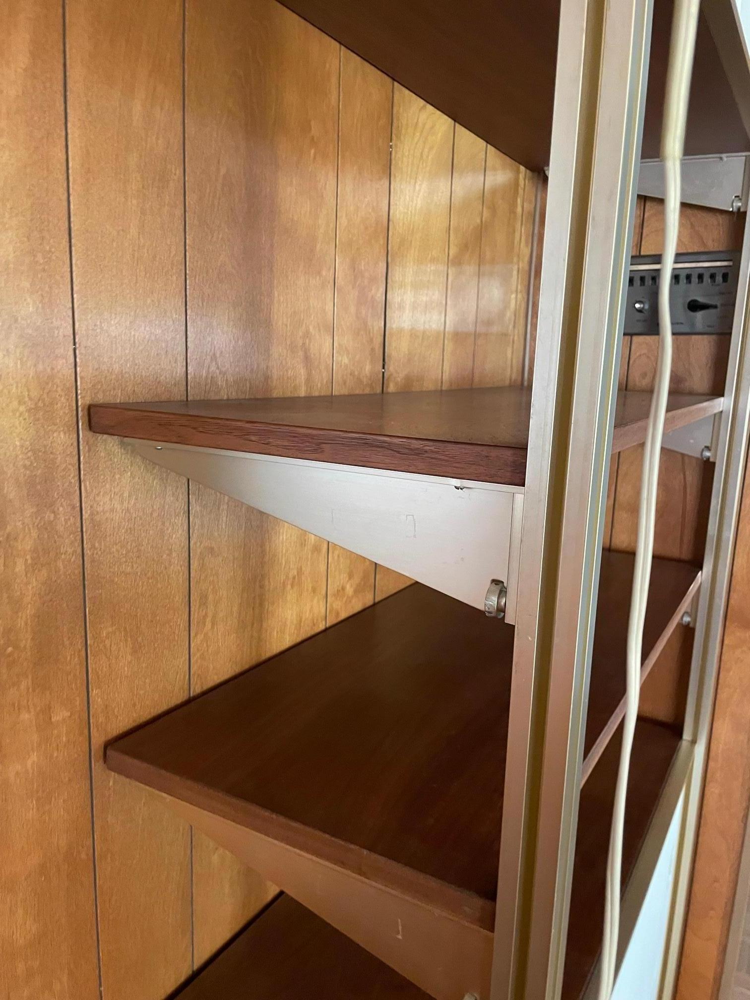 Vintage George Nelson for Herman Miller Omni single bay wall unit. Anodized support, white cabinets and walnut shelves. Original light. Fully adjustable. Shelves and boxes slide to desired height. Up to 96
