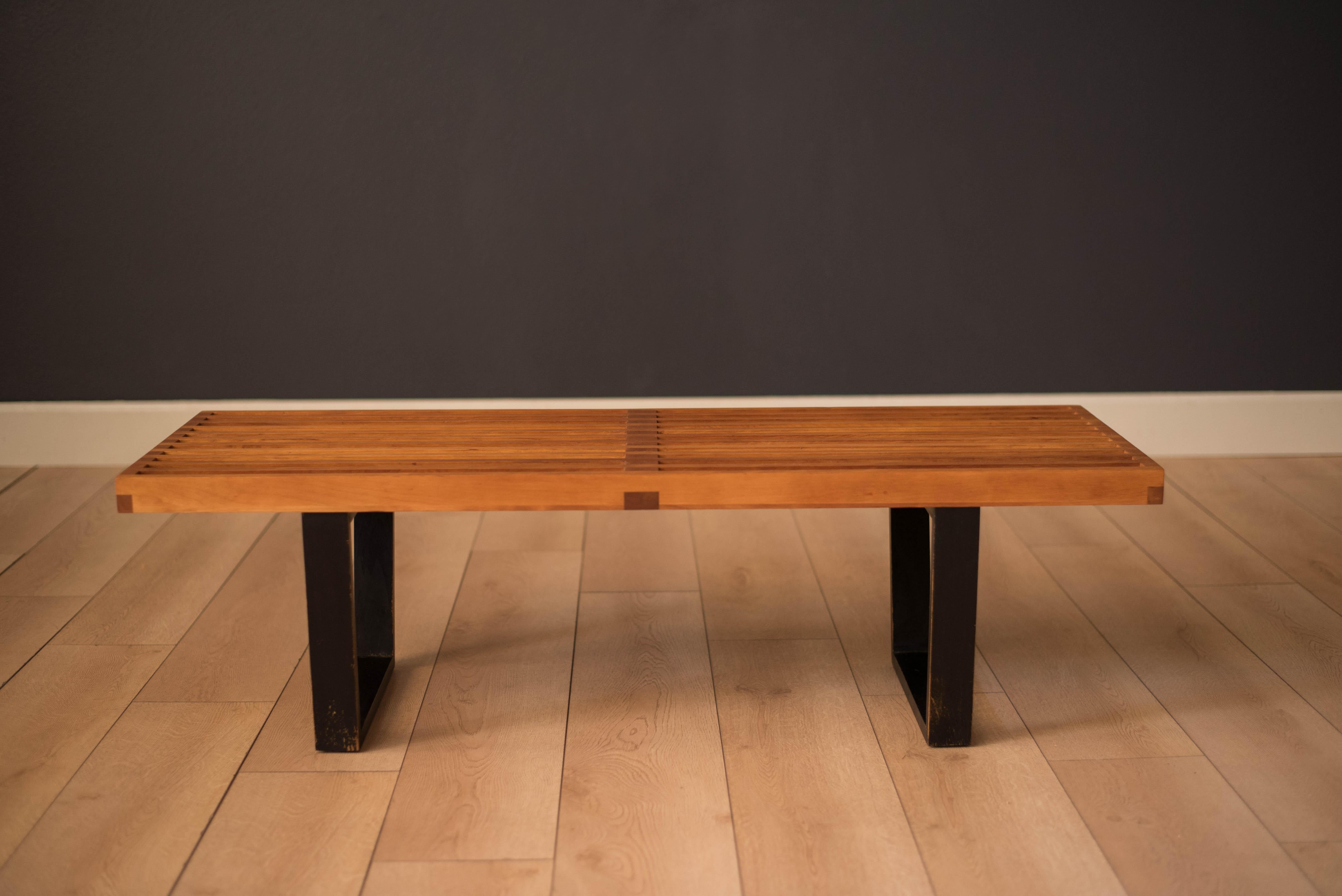 Mid-Century Modern table bench designed by George Nelson for Herman Miller circa 1950s. Originally intended as a platform base for the Basic Cabinet Series, this versatile piece has many uses and can function as a living room coffee table, entryway