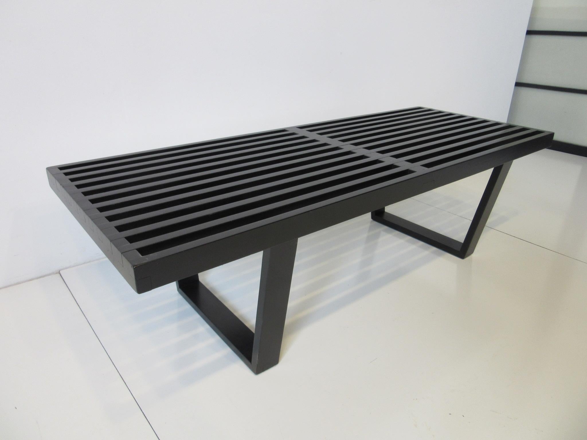A vintage satin black slatted wood bench / coffee table designed by George Nelson this iconic piece is in the smaller size and perfect for that living room, entrance way or the foot of a bed . Manufactured by the Herman Miller furniture company.