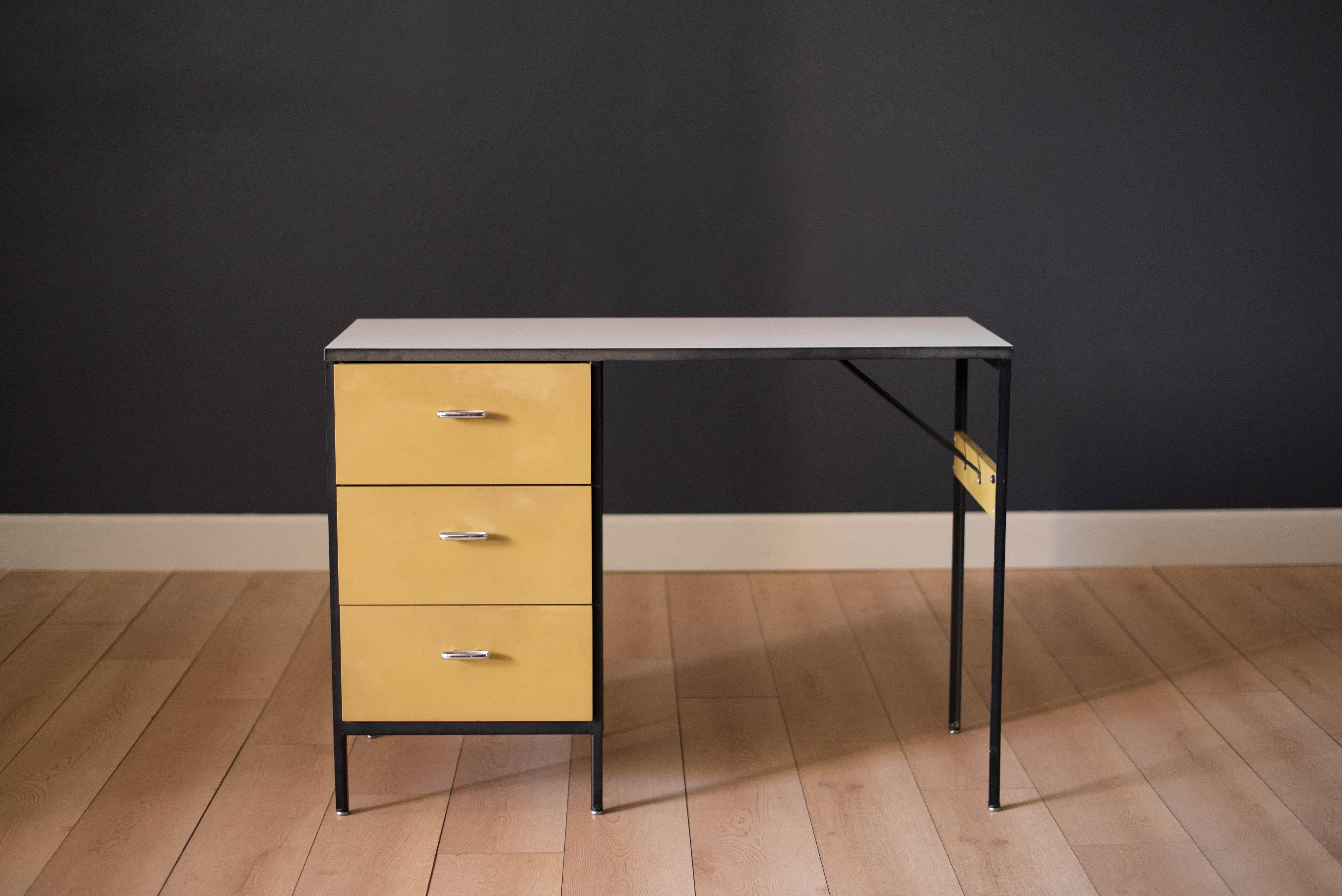 Mid-Century Modern steel frame office desk designed by George Nelson for Herman Miller. This original two-toned piece includes three drawers encased in a black steel frame accessorized by Nelson's signature aluminum handles. White laminate top