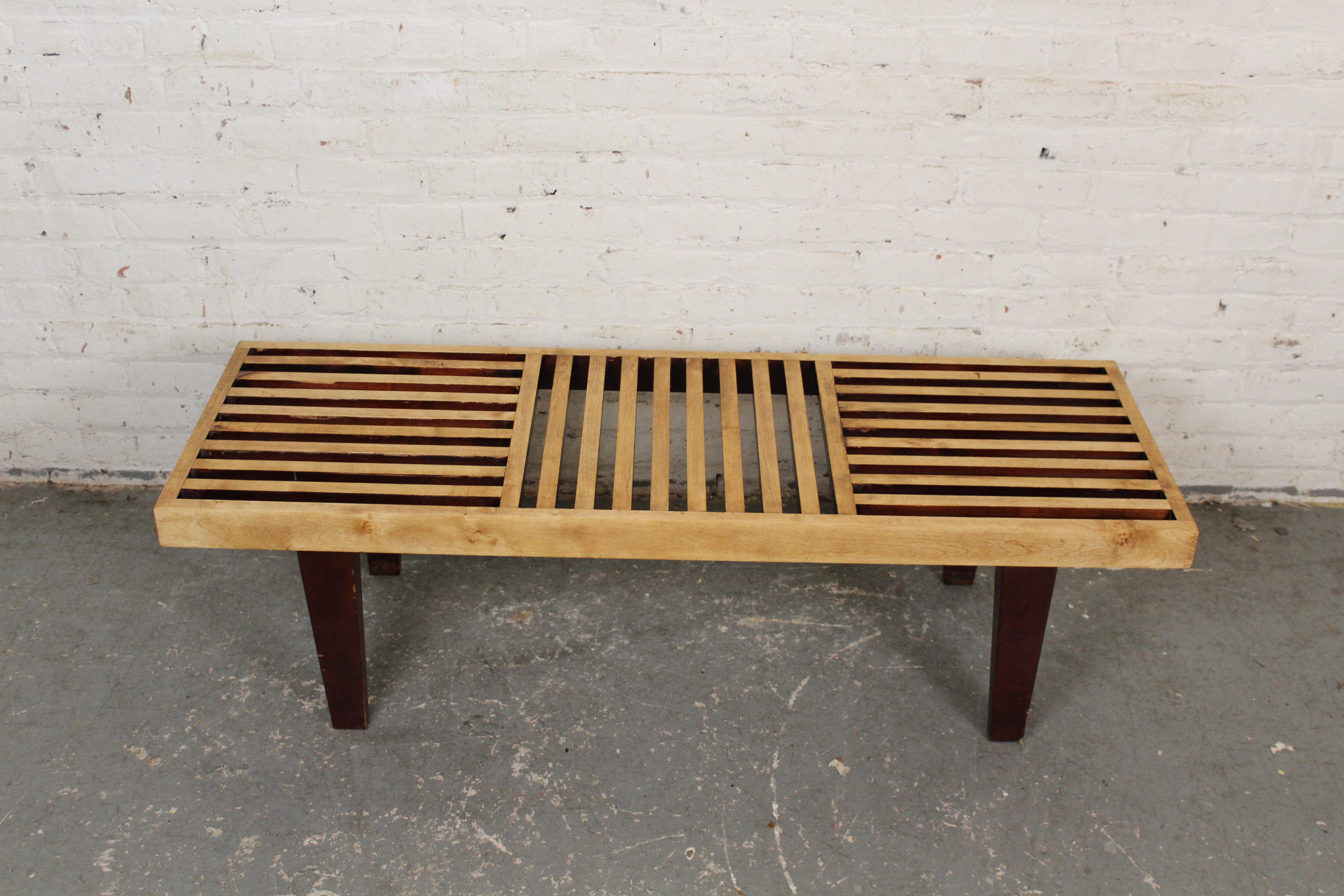 Whether you're using it as a seat or a coffee table, this Nelson style bench has that classic mid-century modern style that you crave! Featuring a slatted oak top and sturdy solid legs, this two-tone table boasts construction that is sure to last