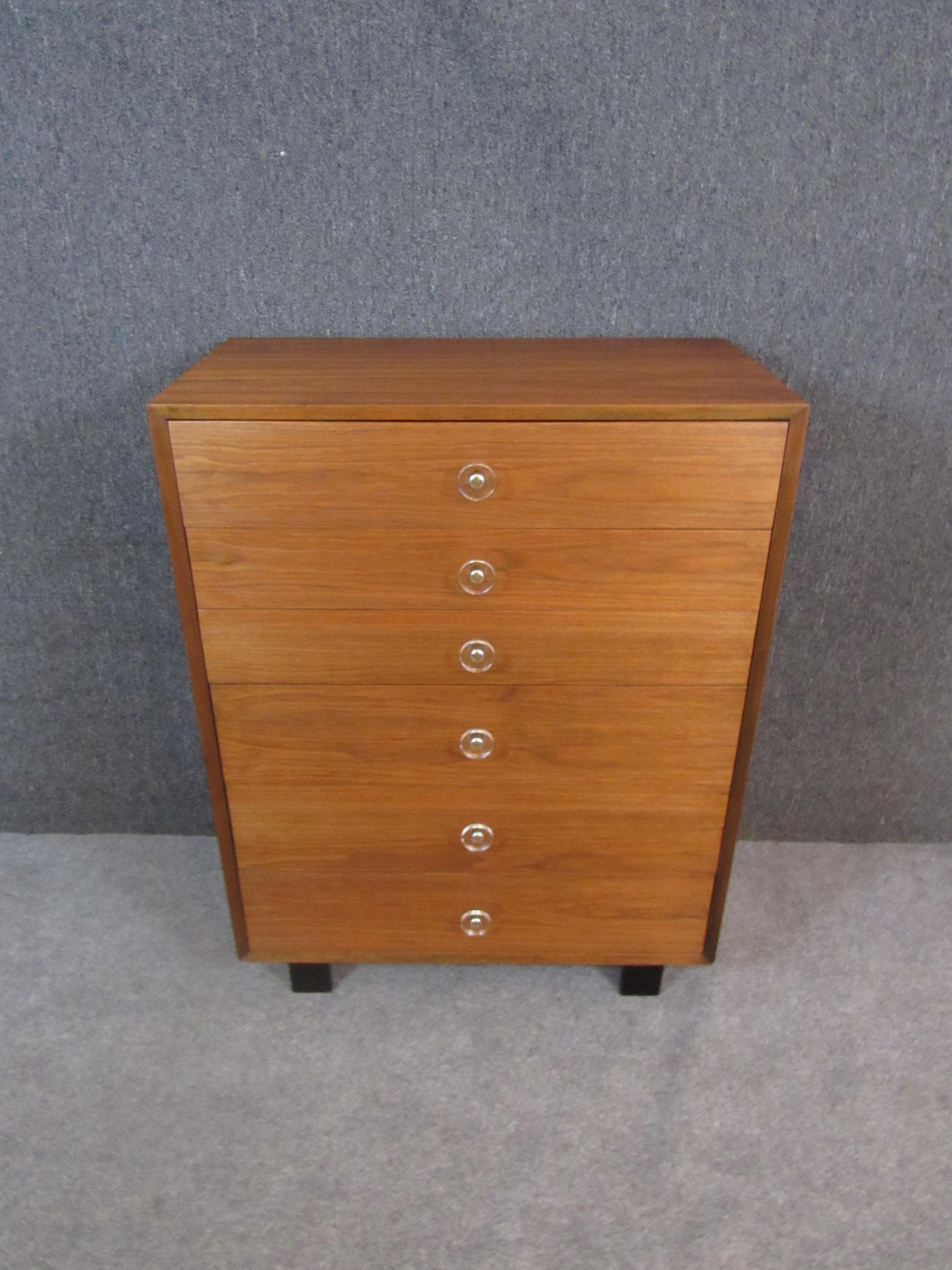 Fantastic vintage Herman Miller tall dresser created by legendary American designer George Nelson. Featuring six ample pull-out drawers, this is the ultimate storage solution for any room. Newly refinished walnut wood grain adds a lovely, natural