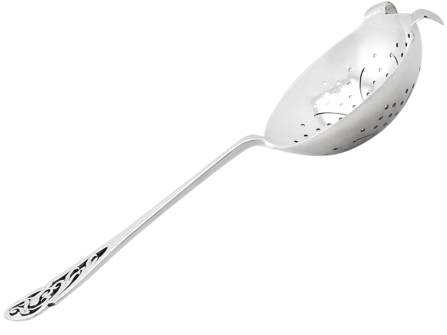 A fine and impressive vintage George VI English sterling silver tea strainer; an addition to our silver teaware collection

This fine vintage sterling silver tea strainer has a circular rounded form.

The bowl of the tea strainer is embellished with