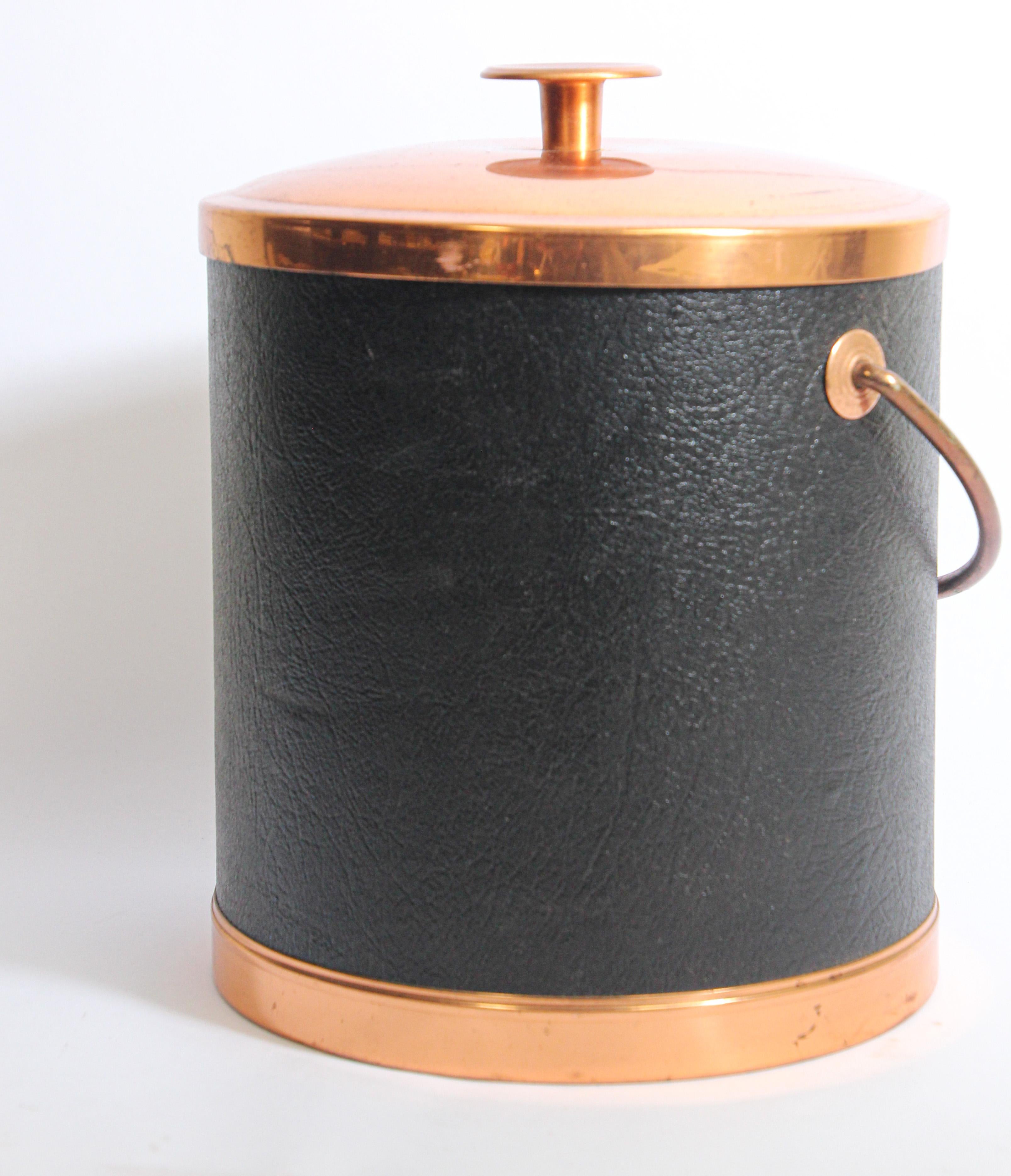 Vintage Copper craft Guild Mid-Century Modern black vinyl covered ice bucket.
The cover and handle are made in copper metal.
Made in USA.
Great gift for him.
Top cover shows some wear.
Hand made in the US by Copper craft Guild, original tag