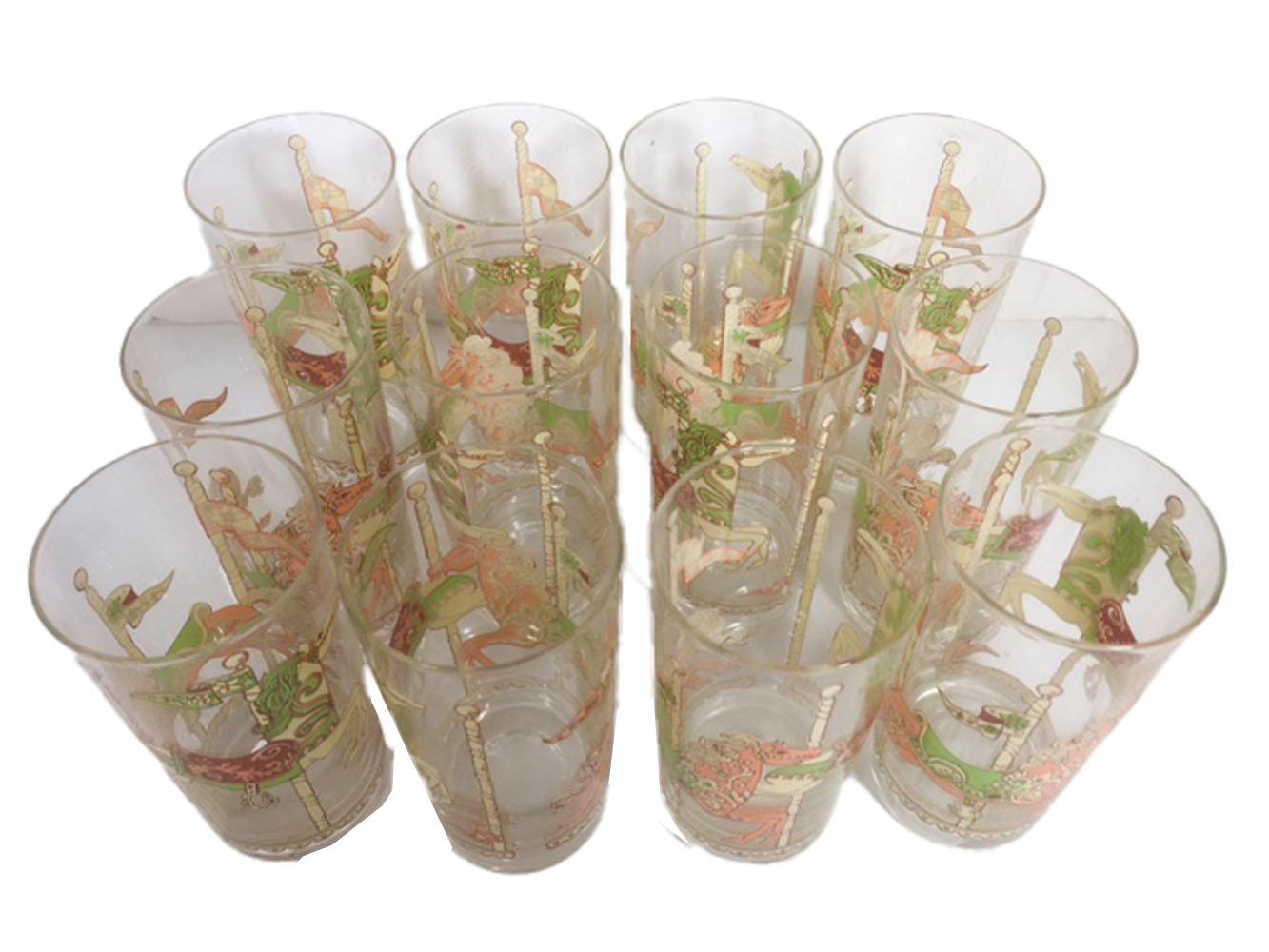 Set of 12 mid-century highball glasses designed by Georges Briard and decorated with carousel horses in cream, pink, green and rust enamel. All in excellent condition.