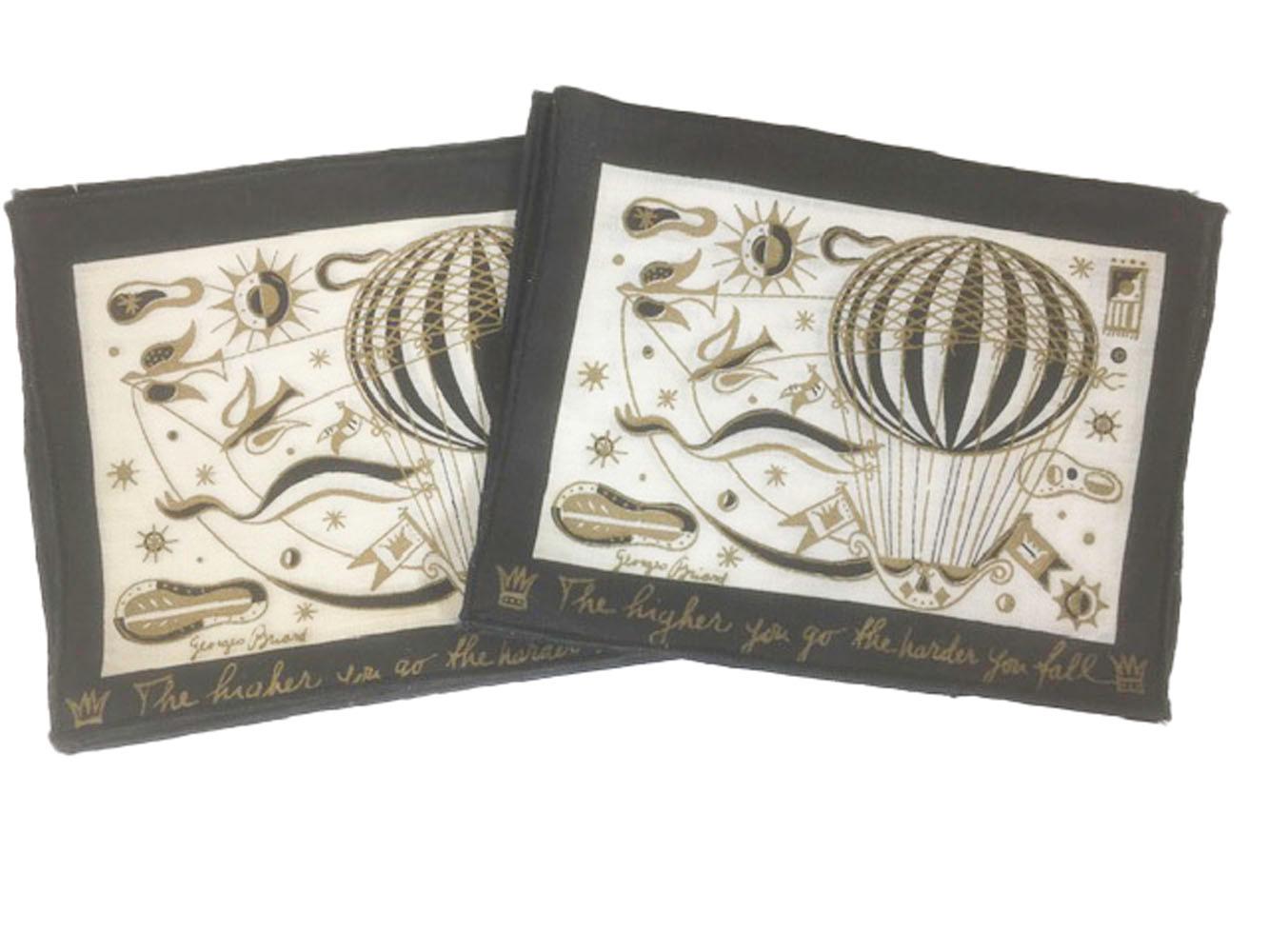 Boxed et of 8 vintage Georges Briard linen cocktail napkins printed in black with gold and having a hot air balloon motif inside a black border. The bottom border with the words 