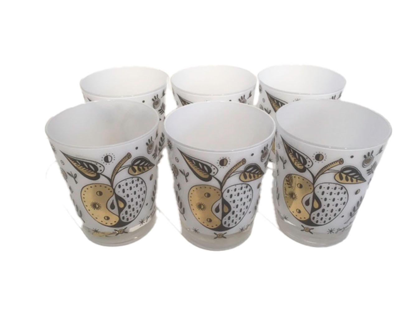 Mid-Century Modern, set of six double old fashioned glasses designed by Georges Briard in the forbidden fruit pattern with white frosted interiors on clear glass. The exterior of the glasses decorated with apples and other elements in black enamel