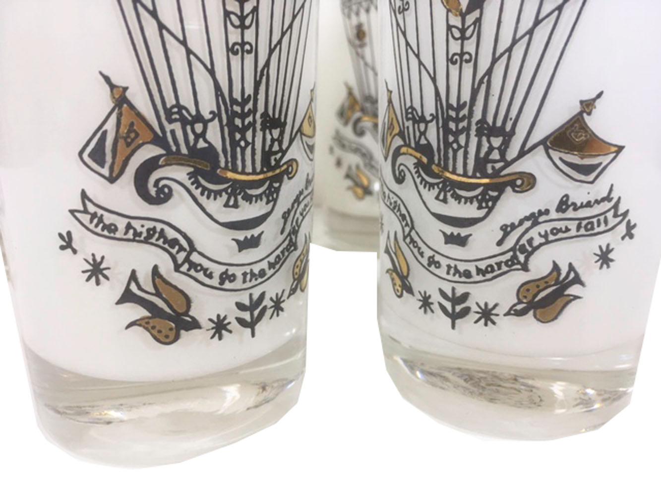 Set of eight Georges Briard hot air balloon highball glasses. White interior frosted clear glass with a hot air balloon in black and aqua enamel with 22 karat gold. The banner below the balloon reads 