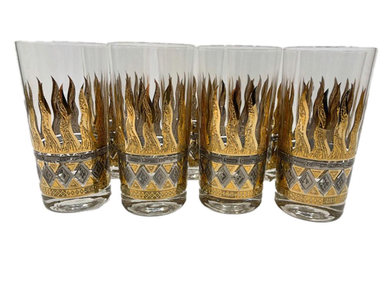 Set of 8 Mid-Century Modern highball glasses designed by Georges Briard having a band of raised gold flames rising from raised bands of gold and silver impressed with geometric Art Deco inspired motifs.