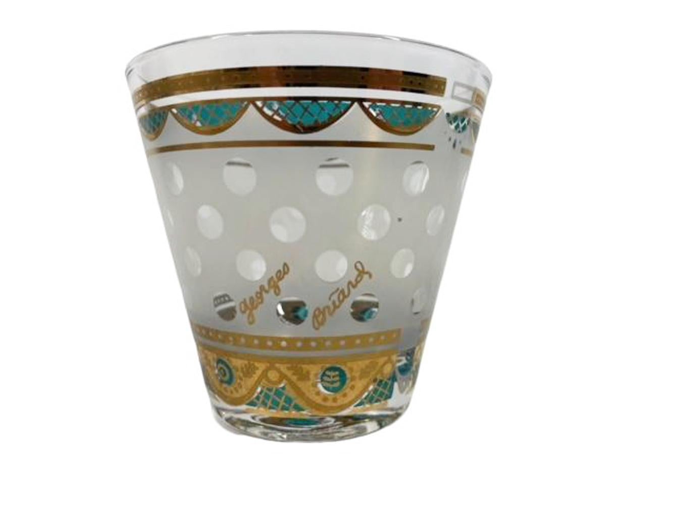 Set of four mid-century old fashioned glasses designed and signed by Georges Briard having a frosted ground with clear polka dots between borders of 22k gold and green enamel swags.