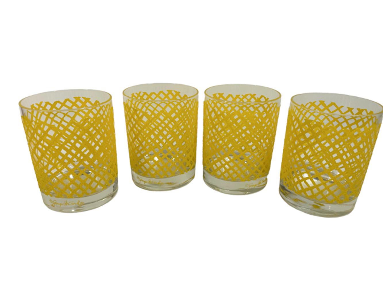 Vintage set of 4 rocks glasses designed by Georges Briard having an irregular pattern of netting in yellow with a raised and textured non-slip surface.