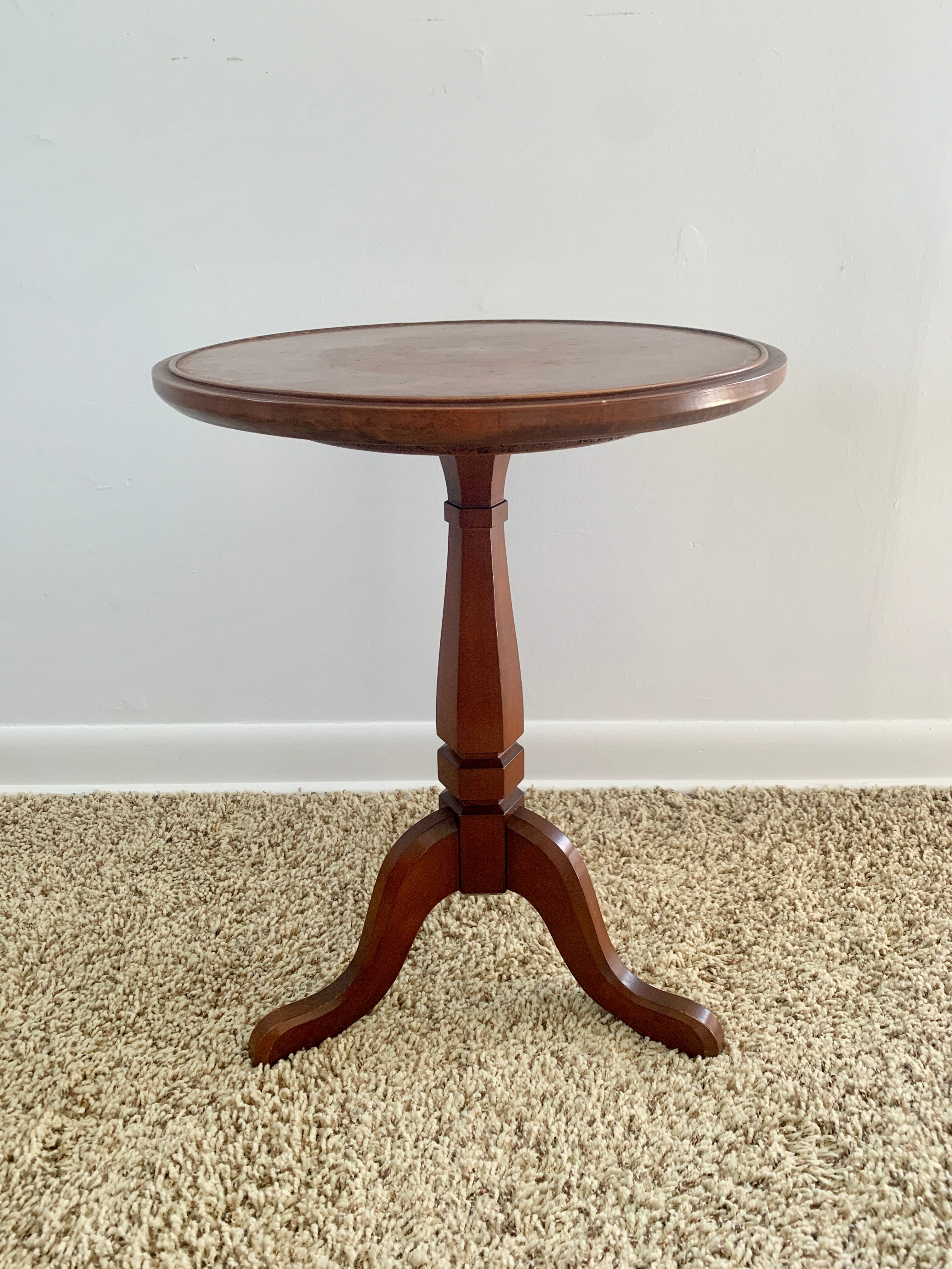 A gorgeous Georgian style round side table or drinks table

USA, Late 20th century

Carved cherry wood, with embossed leather top

Measures: 16