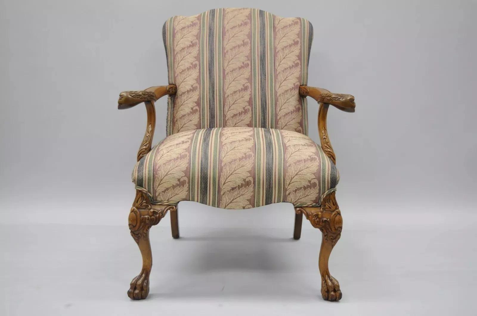 Vintage Georgian Style Carved Mahogany Figural Faces Paw Foot Lounge Arm Chair. Item features solid wood construction, nicely carved details, carved paw feet and knees, carved faces at armrest, nice larger size chair, comfortable form. Circa Mid