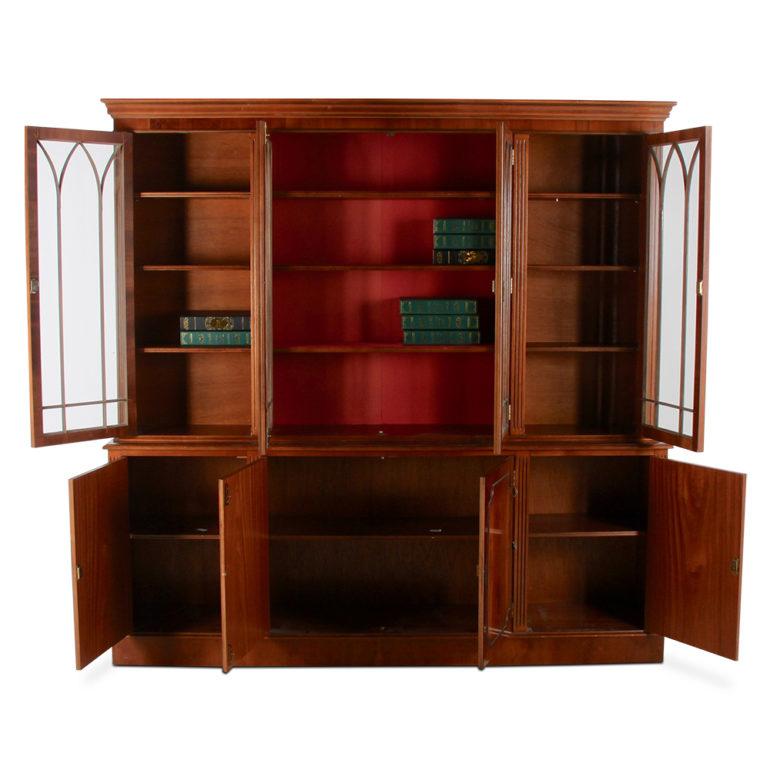A vintage Georgian-style eight-door bookcase with four upper glazed doors and adjustable shelves and four lower cabinets.