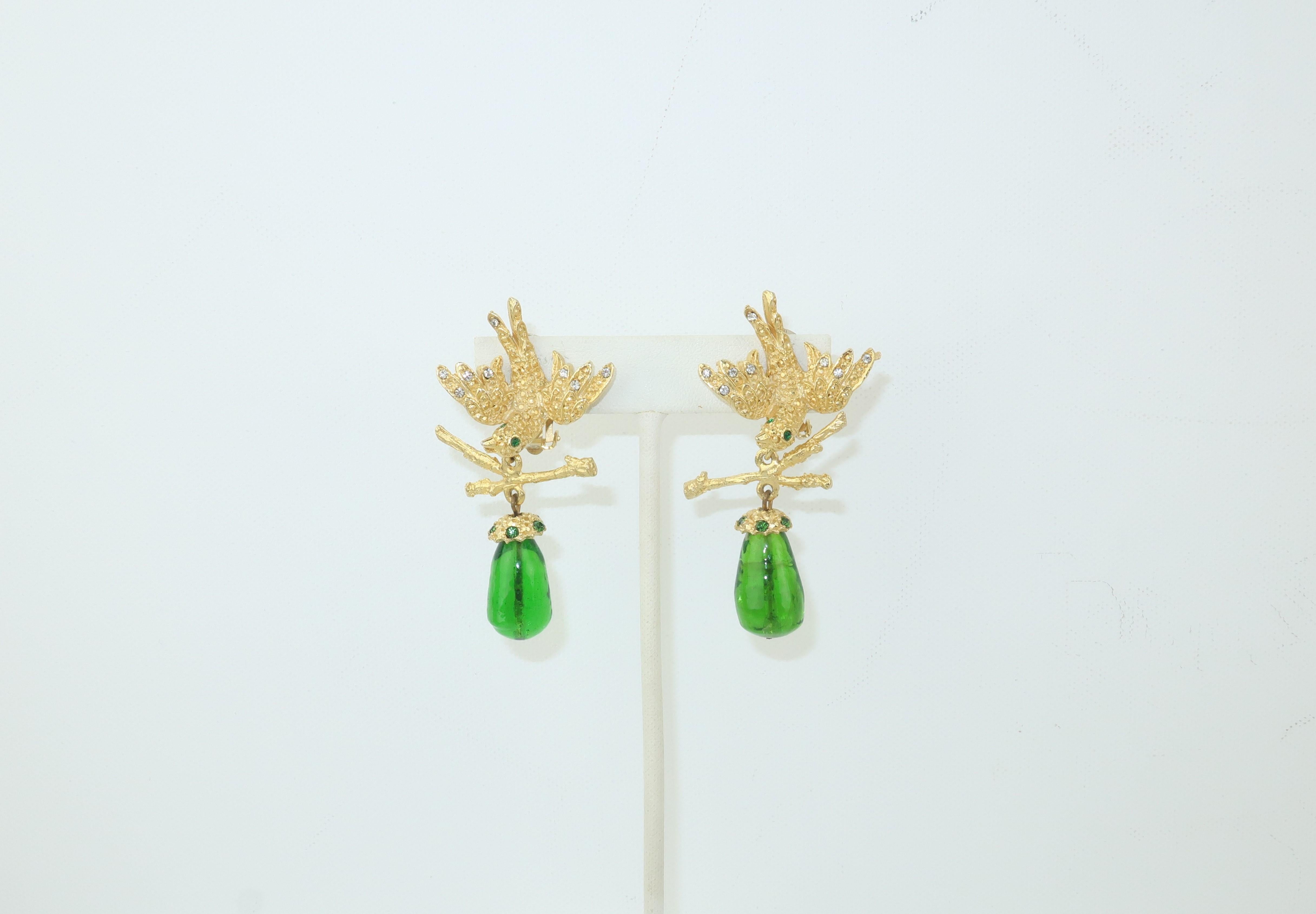 Lovely Gerard Yosca gold tone clip on earrings depicting a bird in flight with an articulated dangle of branches suspending an emerald green glass drop.  The birds are detailed with faceted gold beading accented by crystal rhinestones and feature