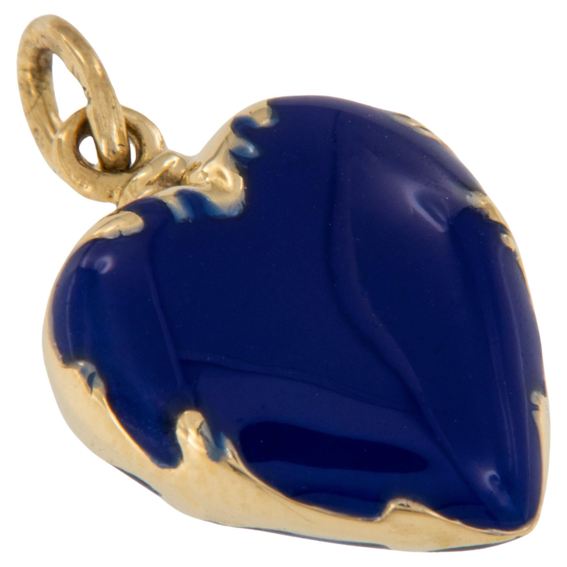 This lovely vintage 18 karat yellow gold German lapis colored enamel heart charm will look lovely suspended from a chain around your neck or hanging off a bracelet. Charm has flowing curved detail on the sides and is in pristine condition. Enameling
