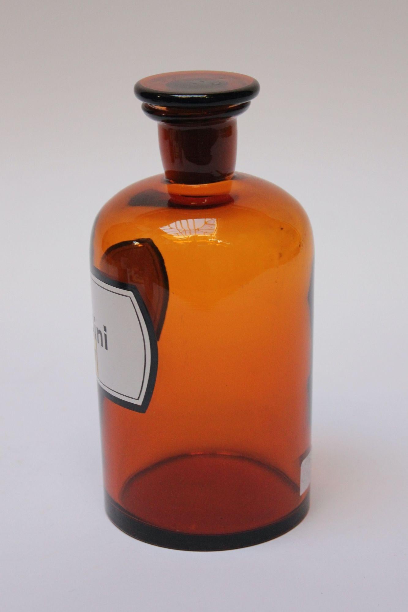 'Ol. Vaselini' pharmacy bottle / apothecary jar (circa late 1920s / early 1930s, Germany).
Amber glass with button stopper and enamel label. 