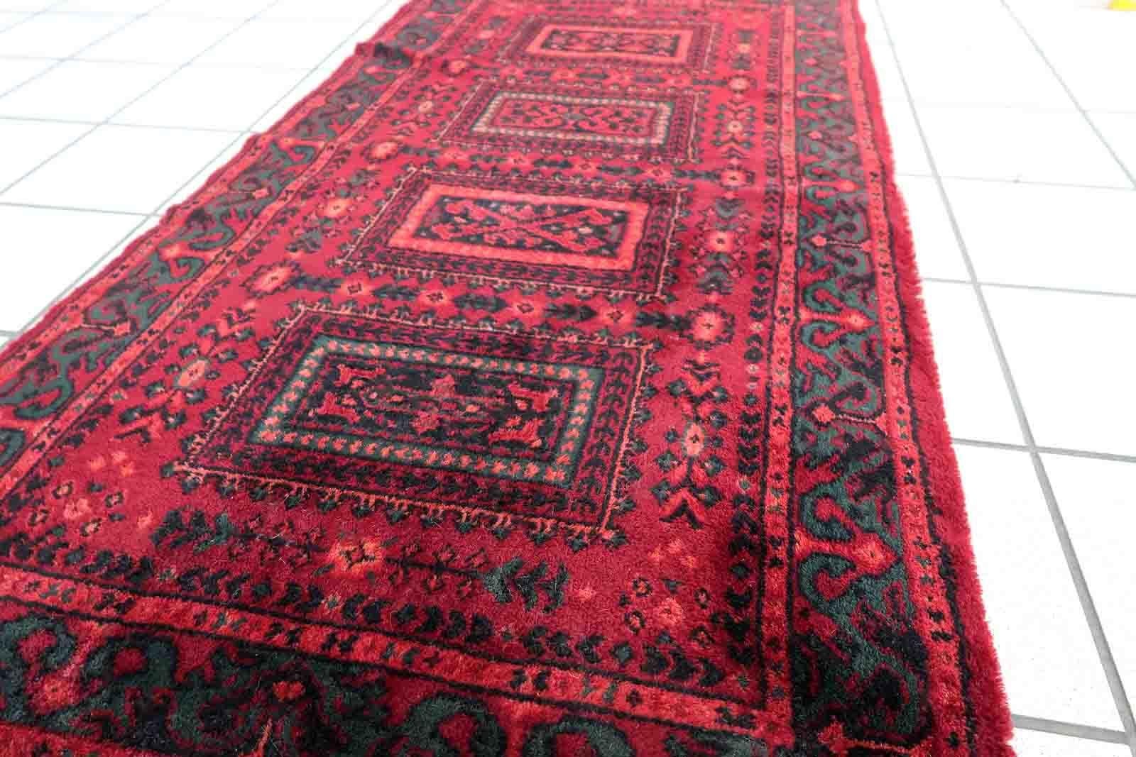 Vintage red woolen rug from Germany made in Baluch style. The rug is in deep red and emerald shades. It is from the middle of 20th century in original good condition.

-condition: original good,

-circa: 1960s,

-size: 2.3' x 4.4' (71cm x