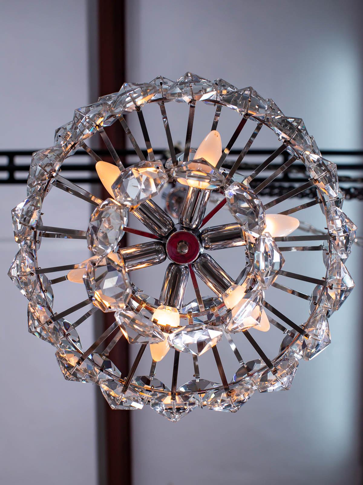 This superb Palwa vintage German crystal and chrome chandelier lighting fixture circa 1970 has a luxurious Minimalist feel. Palwa, the famous German lighting company founded nearly eighty years ago, remains notable for their use of chrome and gilded